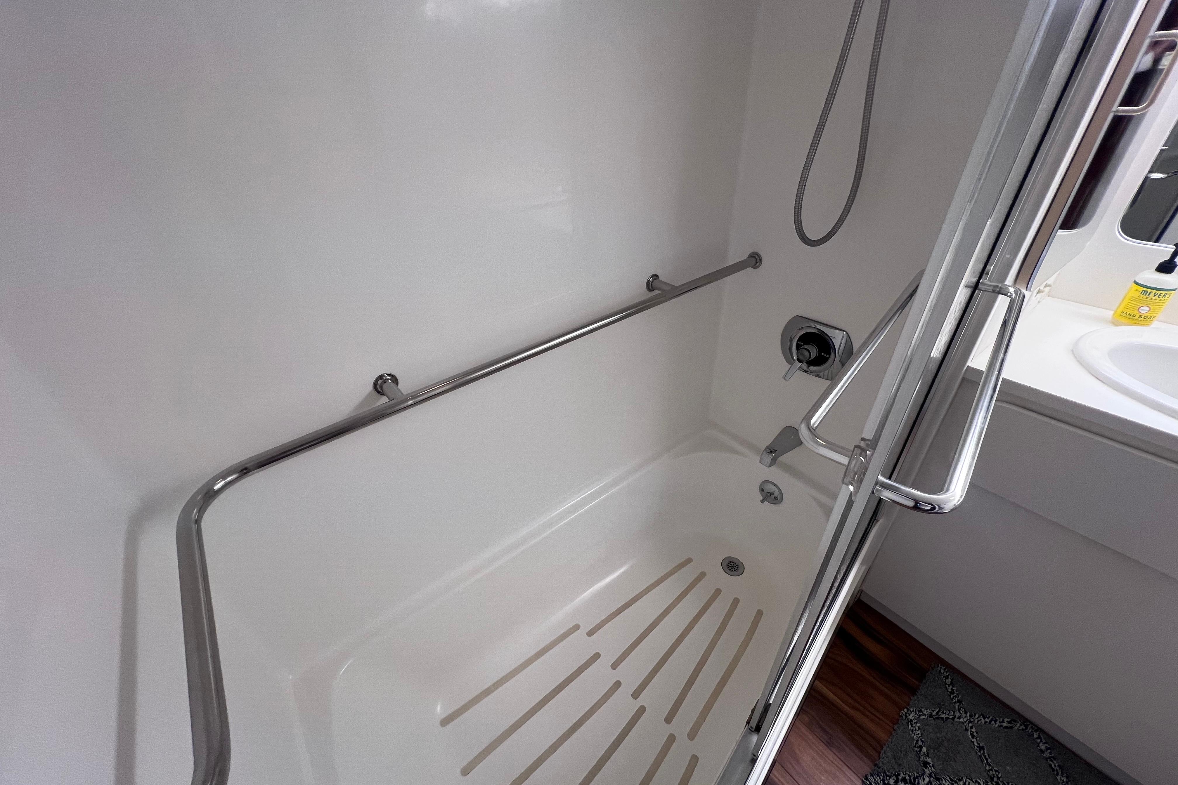 Shower area in 1987 Hatteras 70 Cockpit Motor Yacht with stainless steel fixtures.