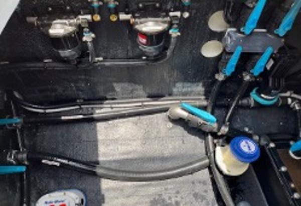 Engine compartment of a 2022 Yellowfin 39 Offshore boat, showcasing mechanical components and wiring.