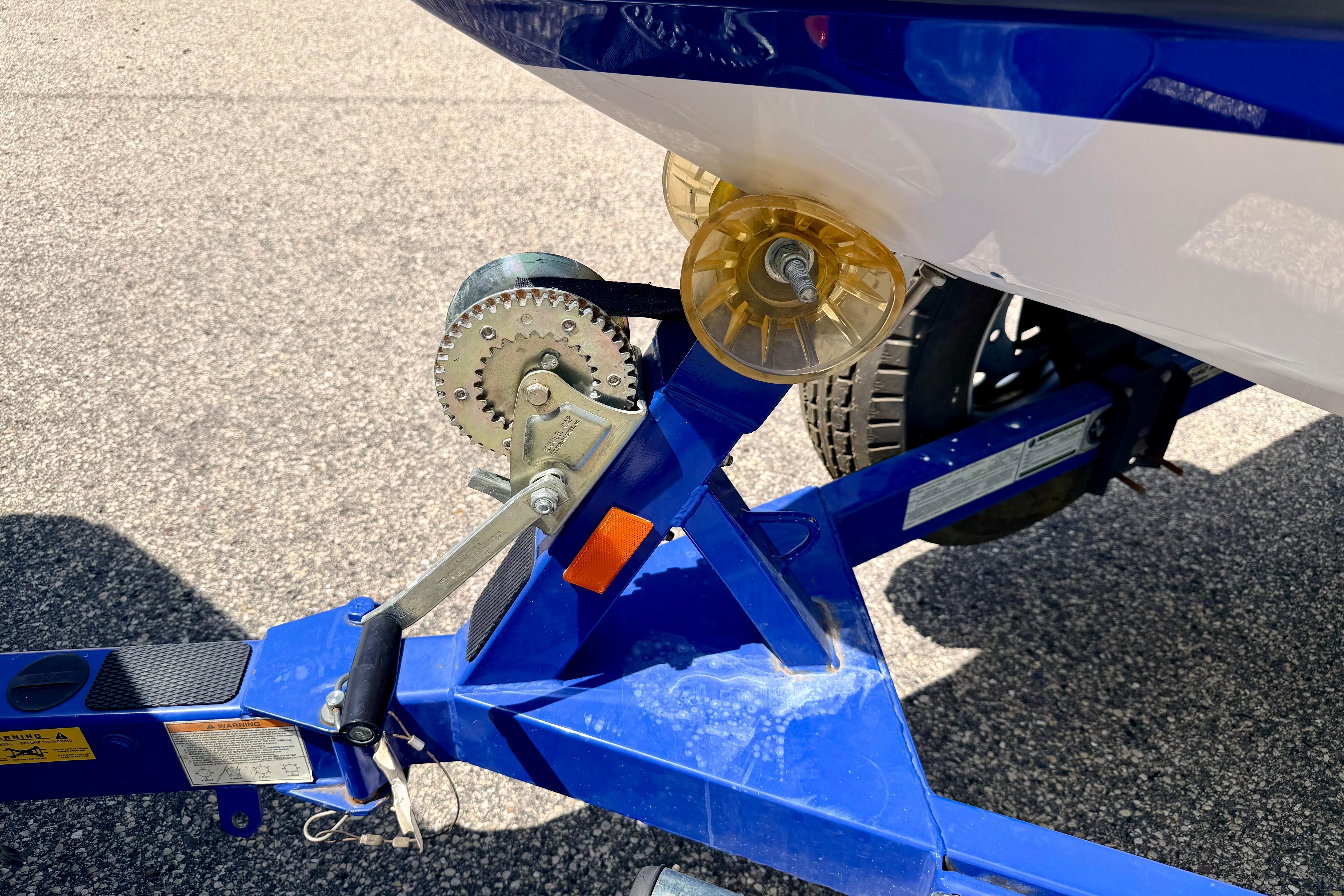 2008 Moomba Outback V boat trailer with winch and roller on asphalt.