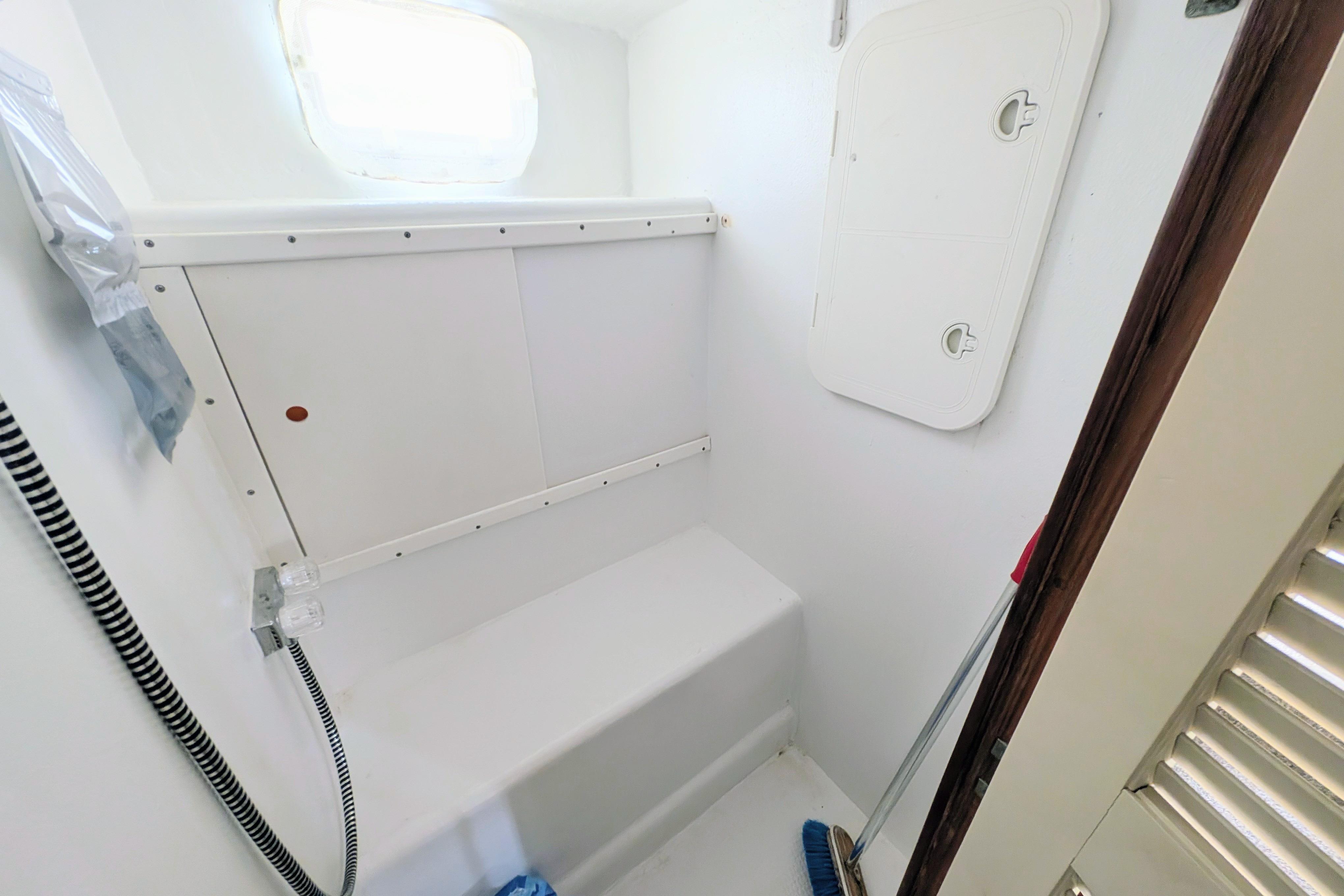 Interior of a 1998 Markley 46 boat, featuring a compact, white storage area.