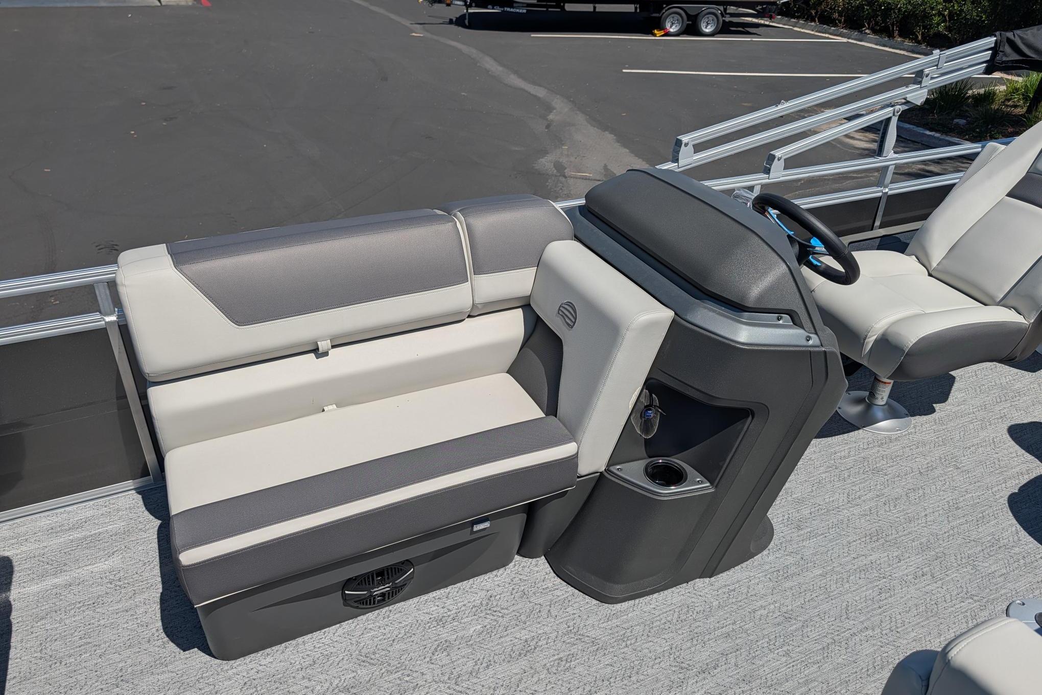 2026 Sun Tracker Fishin' Barge 22 DLX interior with seating and steering console.