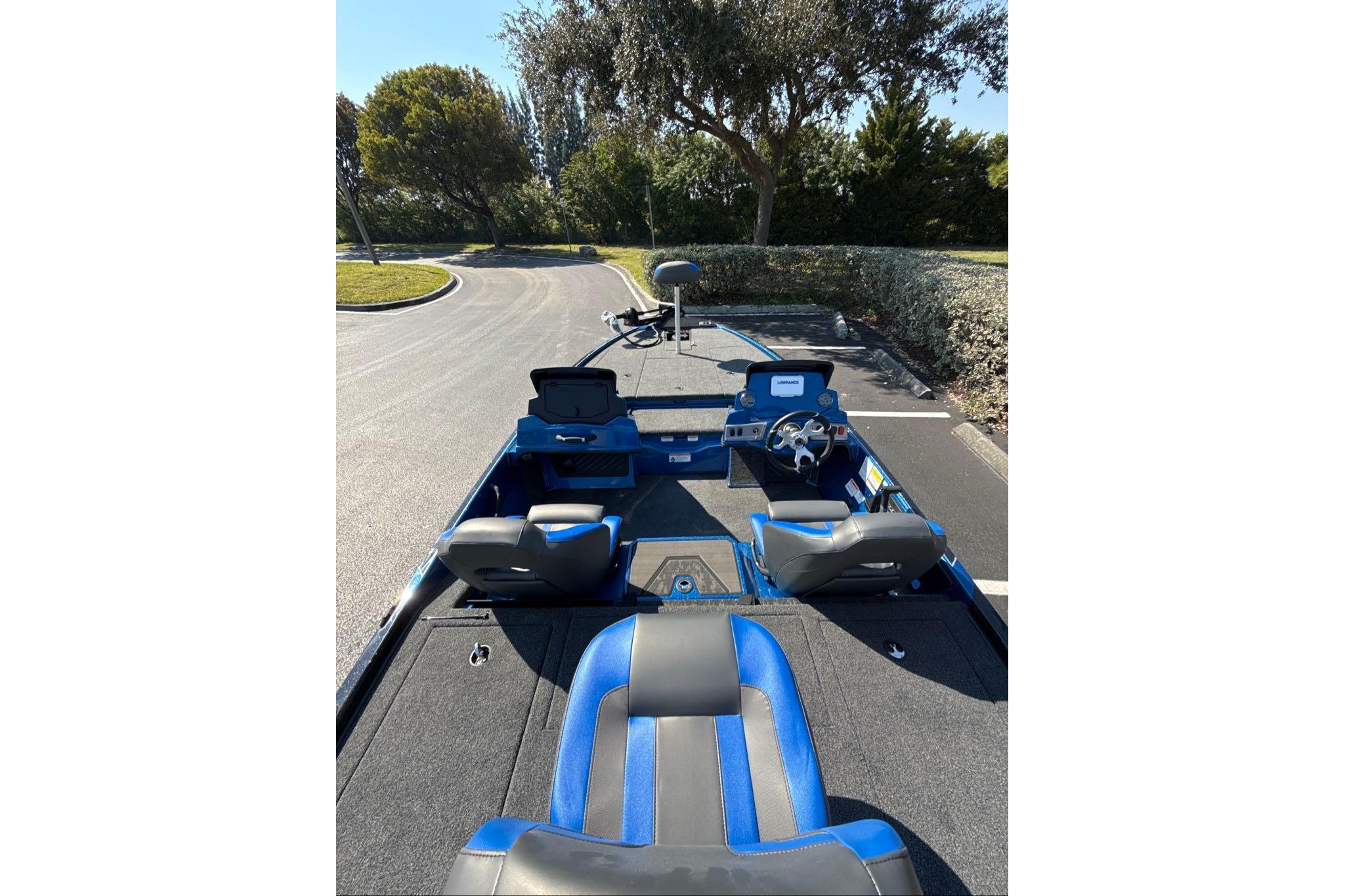2026 Nitro Z19 XL boat interior with blue and black seating, parked outdoors.