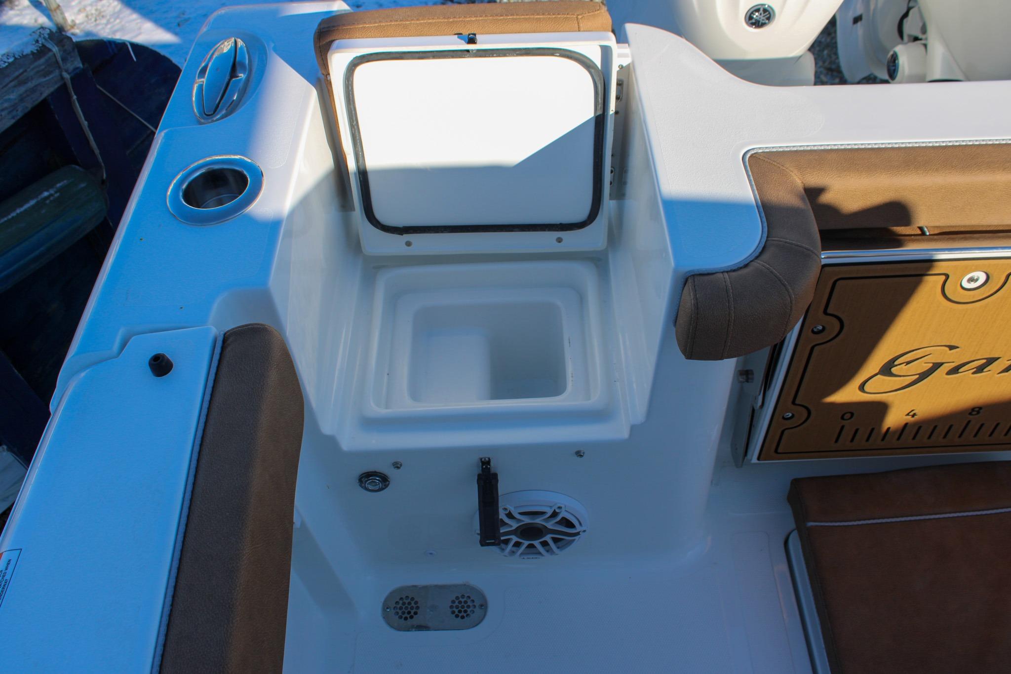 2026 Sea Hunt Gamefish 25 boat interior with open storage compartment and seating.