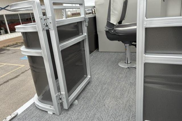 2026 Sun Tracker Fishin' Barge 22 DLX pontoon boat interior with seating and railing.