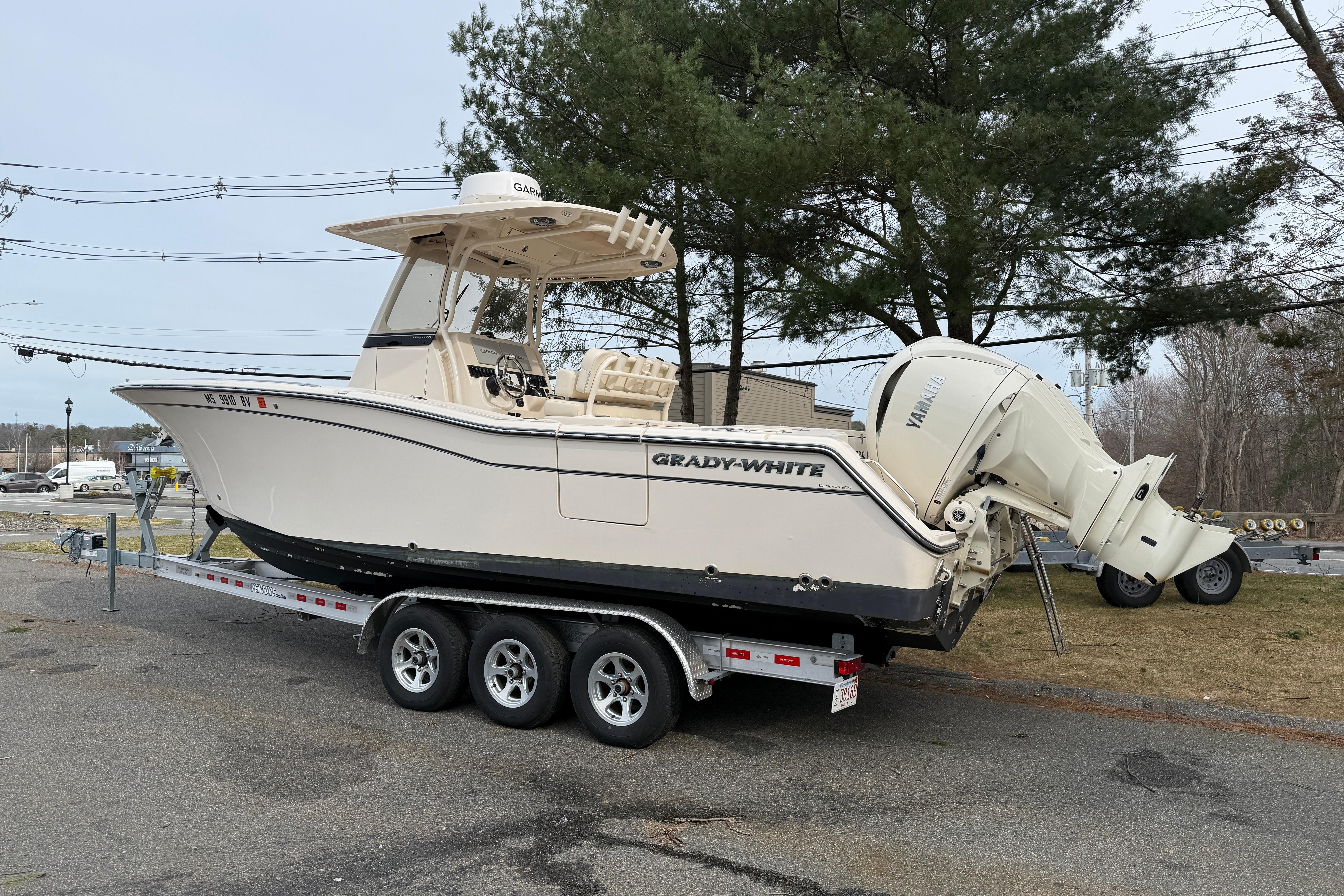 2024 Grady-White Canyon 271 boat on trailer, parked outdoors.