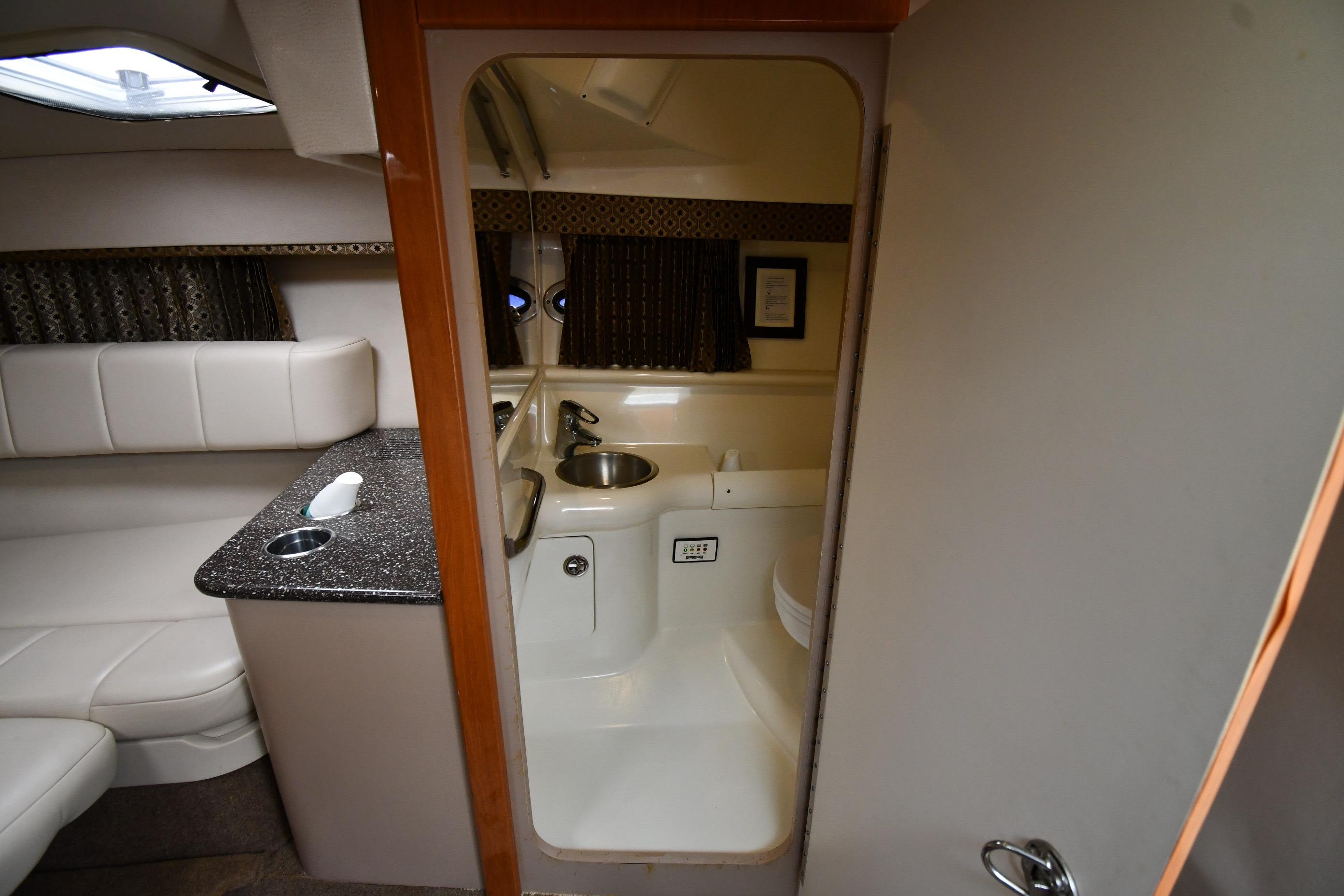 2004 Formula 330 Sun Sport cabin interior with kitchenette and seating area.