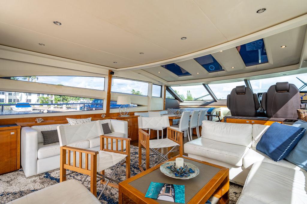 Luxurious interior of 2010 Princess V78 yacht with elegant seating and panoramic windows.