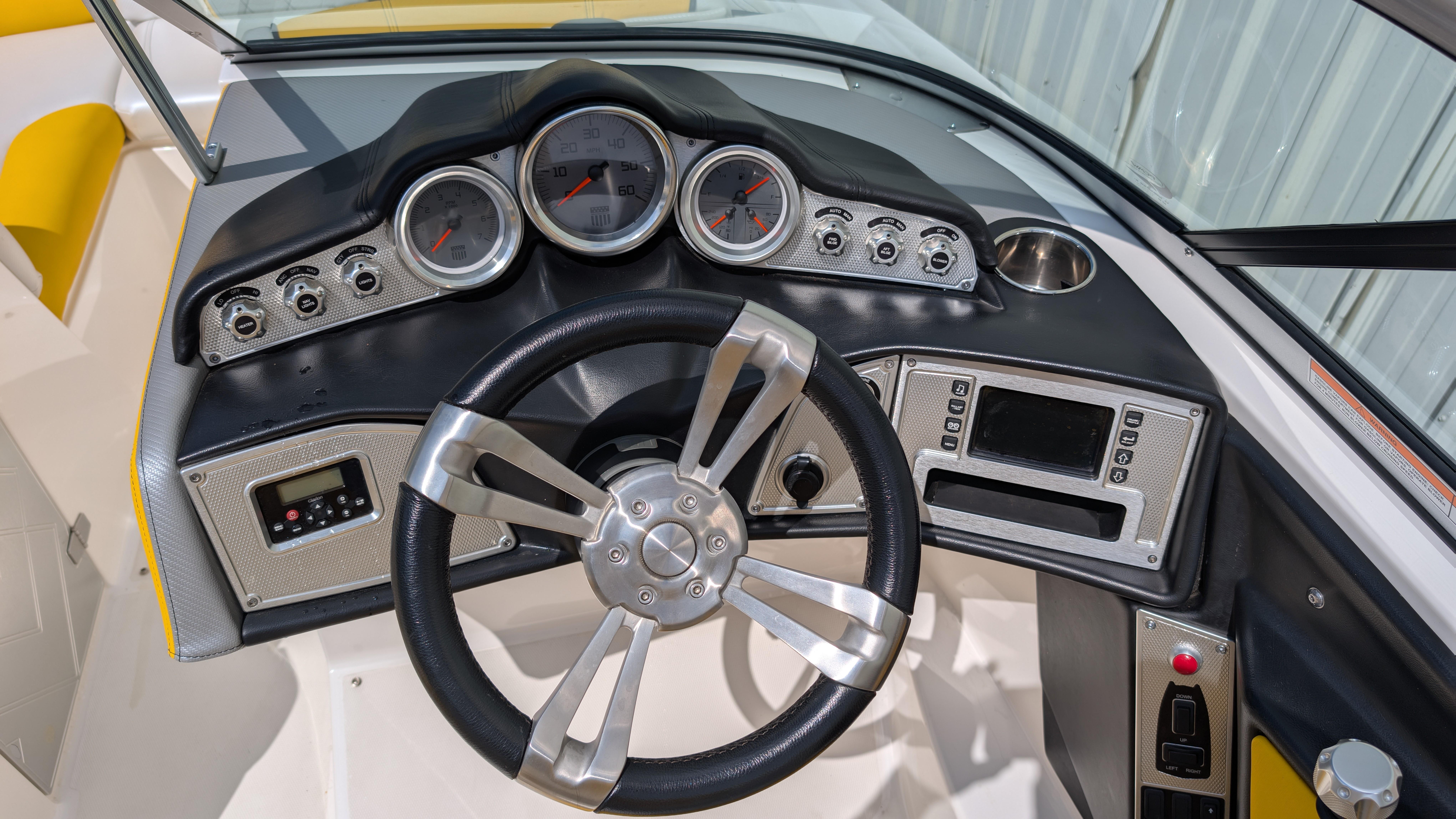 2013 MasterCraft X2 boat dashboard with steering wheel and gauges.