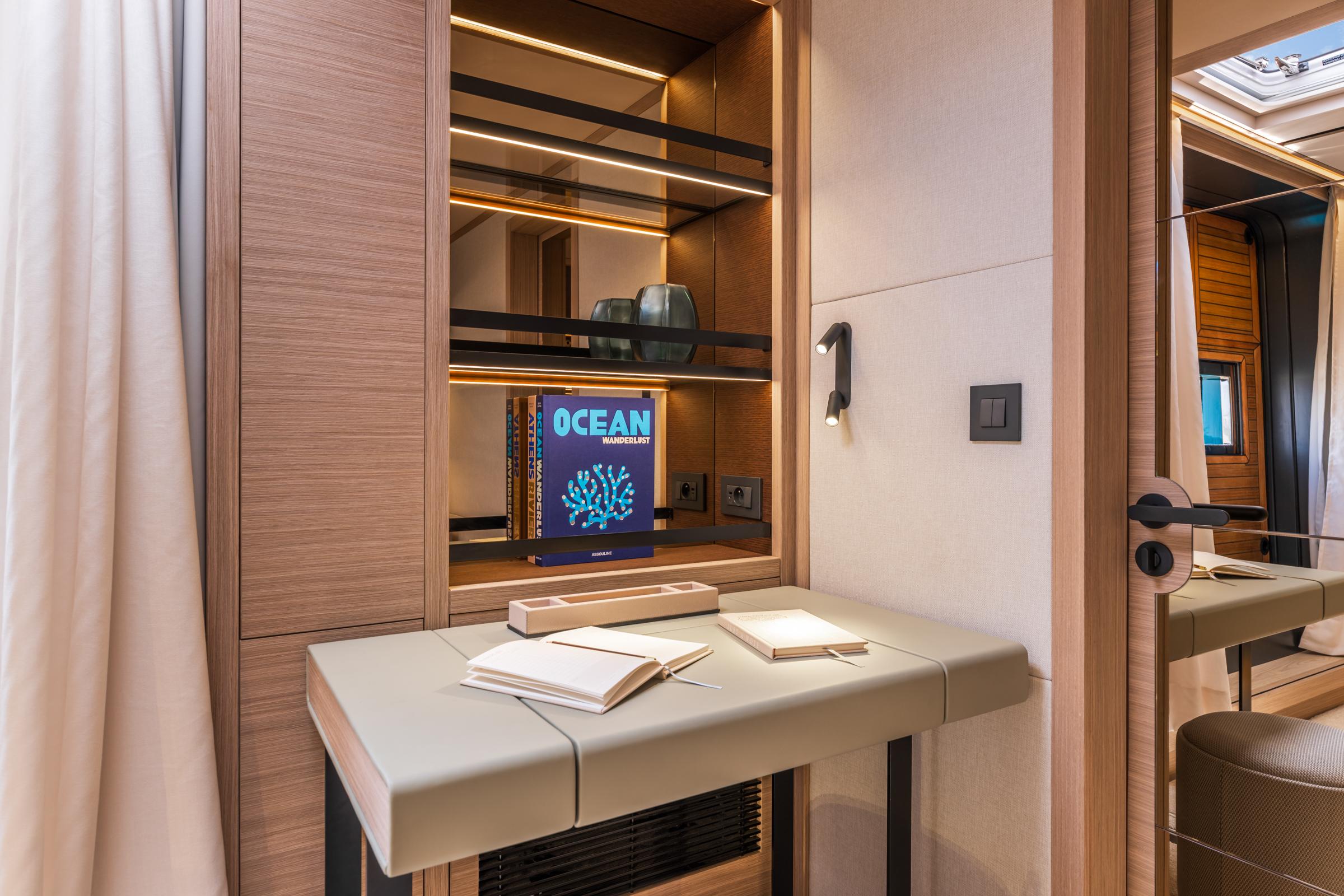Luxurious interior of 2025 Lagoon Eighty 2 yacht with modern desk and shelving.
