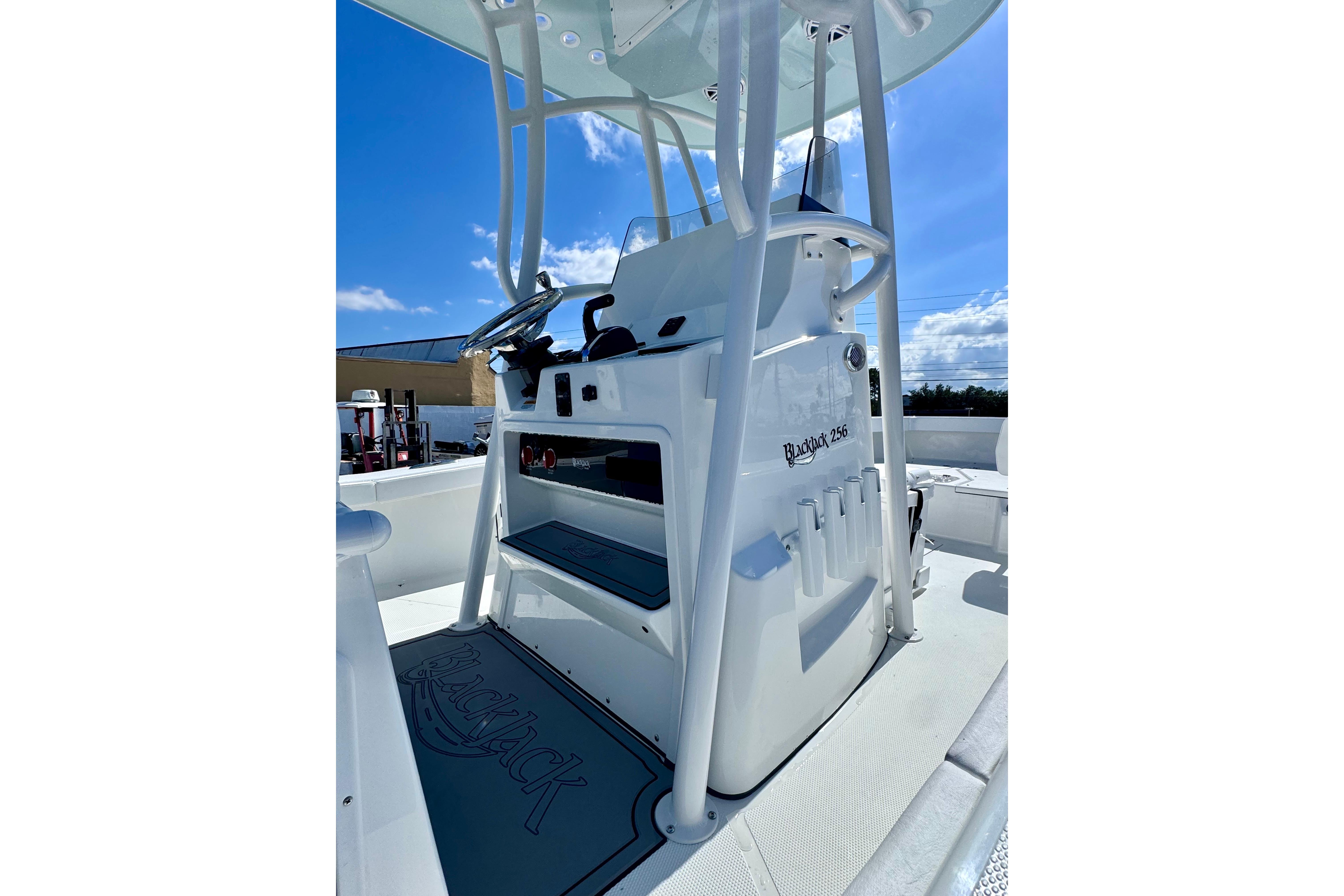 2026 BlackJack 256 Coastal boat console under clear blue sky.