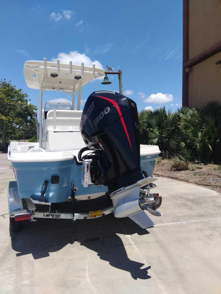 2025 Mako 24 APEX boat with powerful outboard motor, parked outdoors under clear sky.