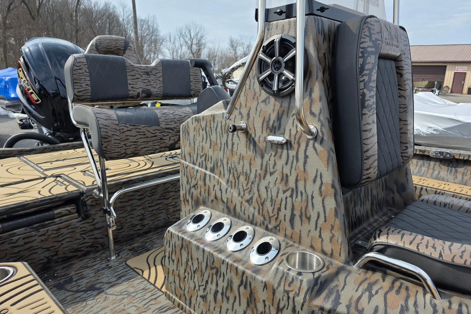 2026 Xpress H22B Bay boat interior with camo design and seating.