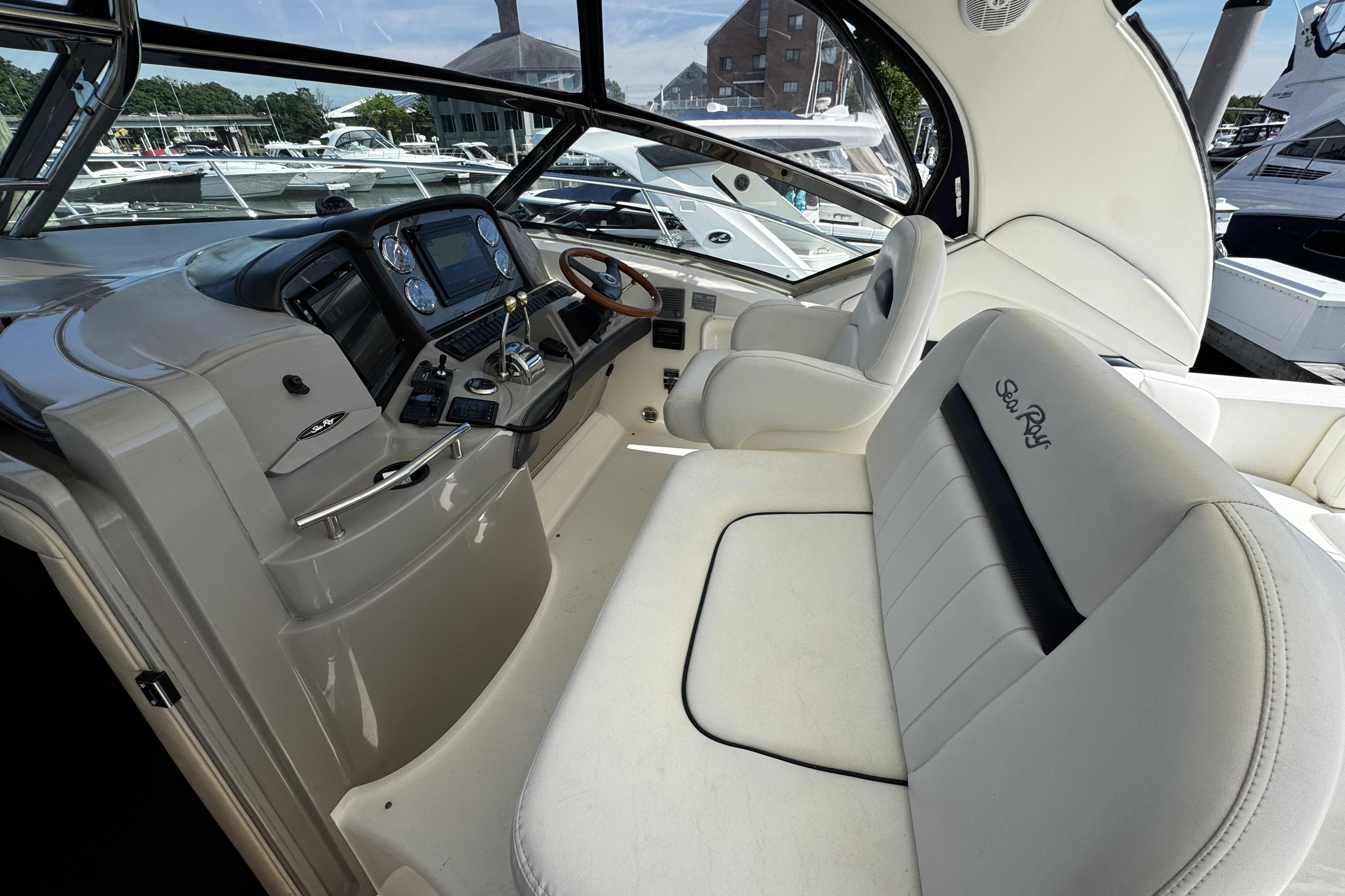 2006 Sea Ray 40 Sundancer cockpit with steering wheel and control panel.