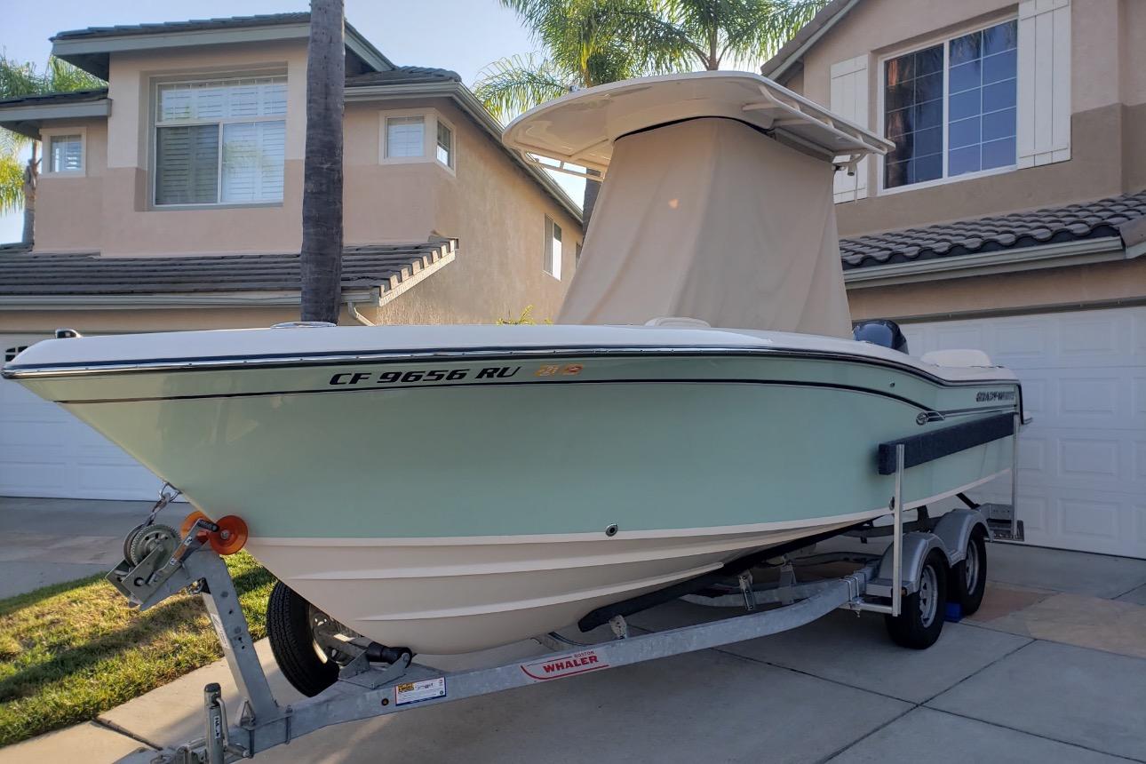 2018 Grady-White Fisherman 216 boat on trailer in residential driveway.