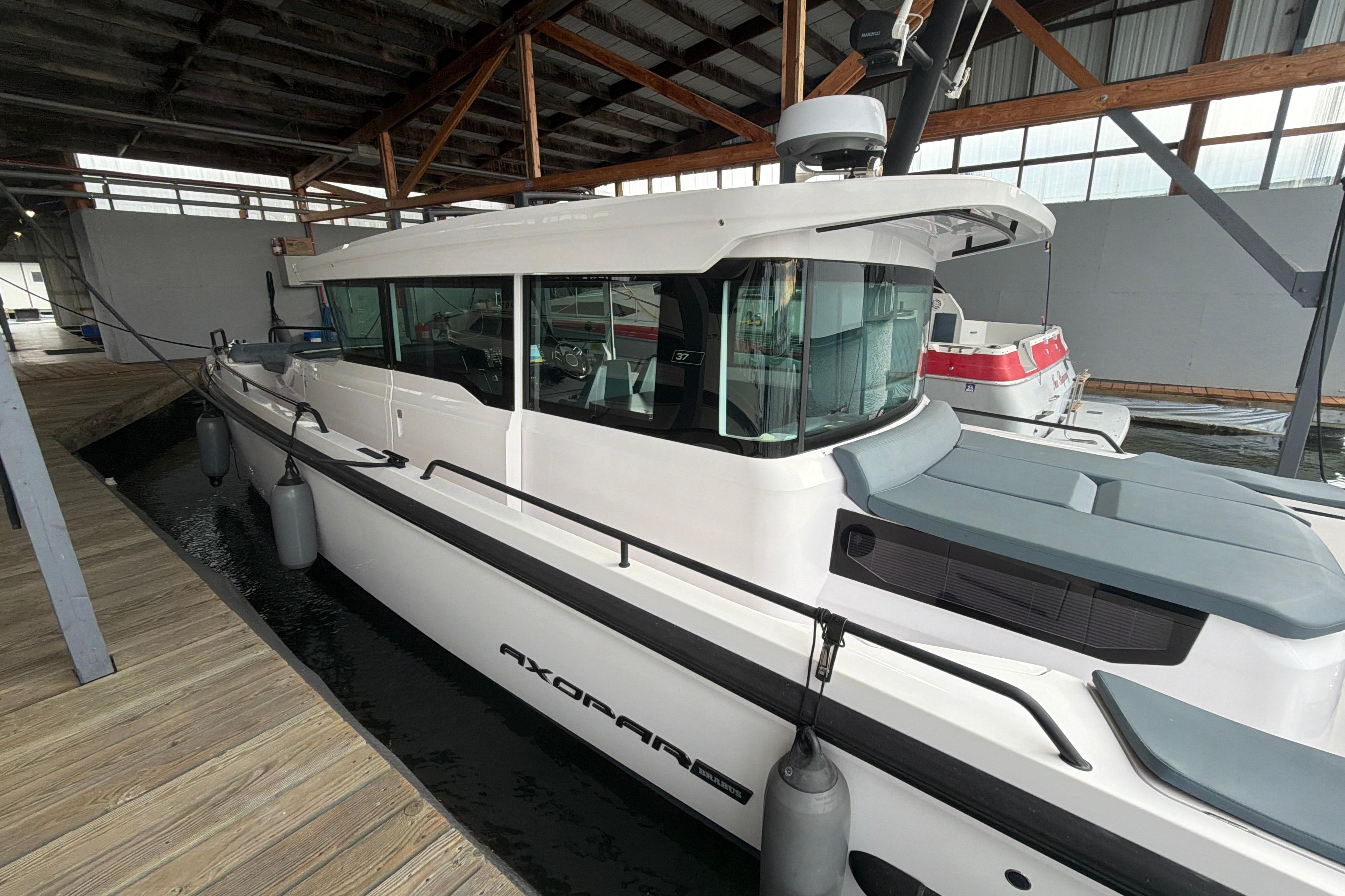 2022 Axopar Brabus 37 XC Cross Cabin docked in a covered marina.