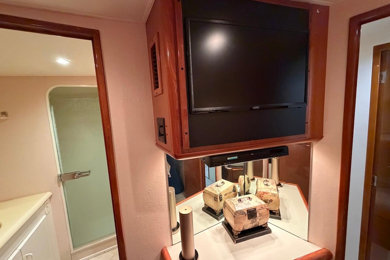 Interior of 1999 Viking 58 Convertible yacht with TV and bathroom view.