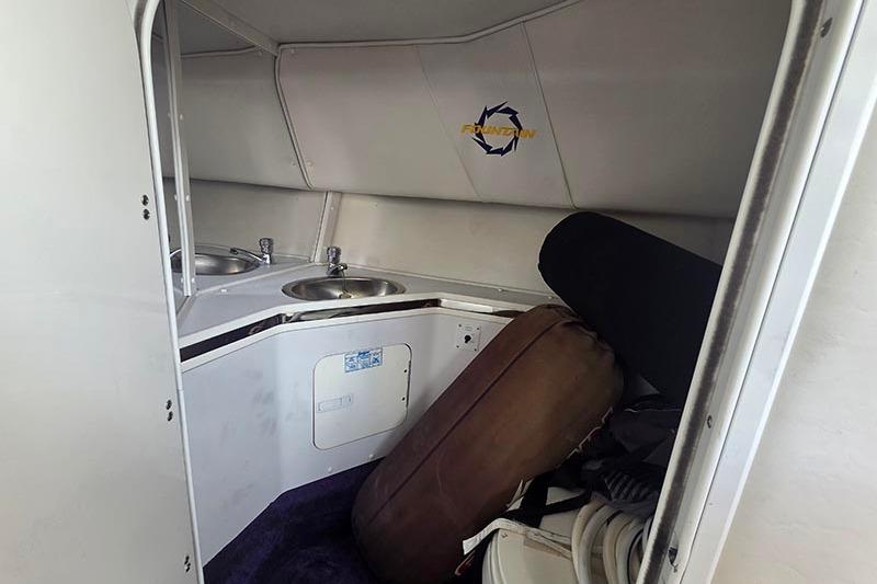 Interior of a 2004 Fountain 38 Lightning boat with sink and storage area.