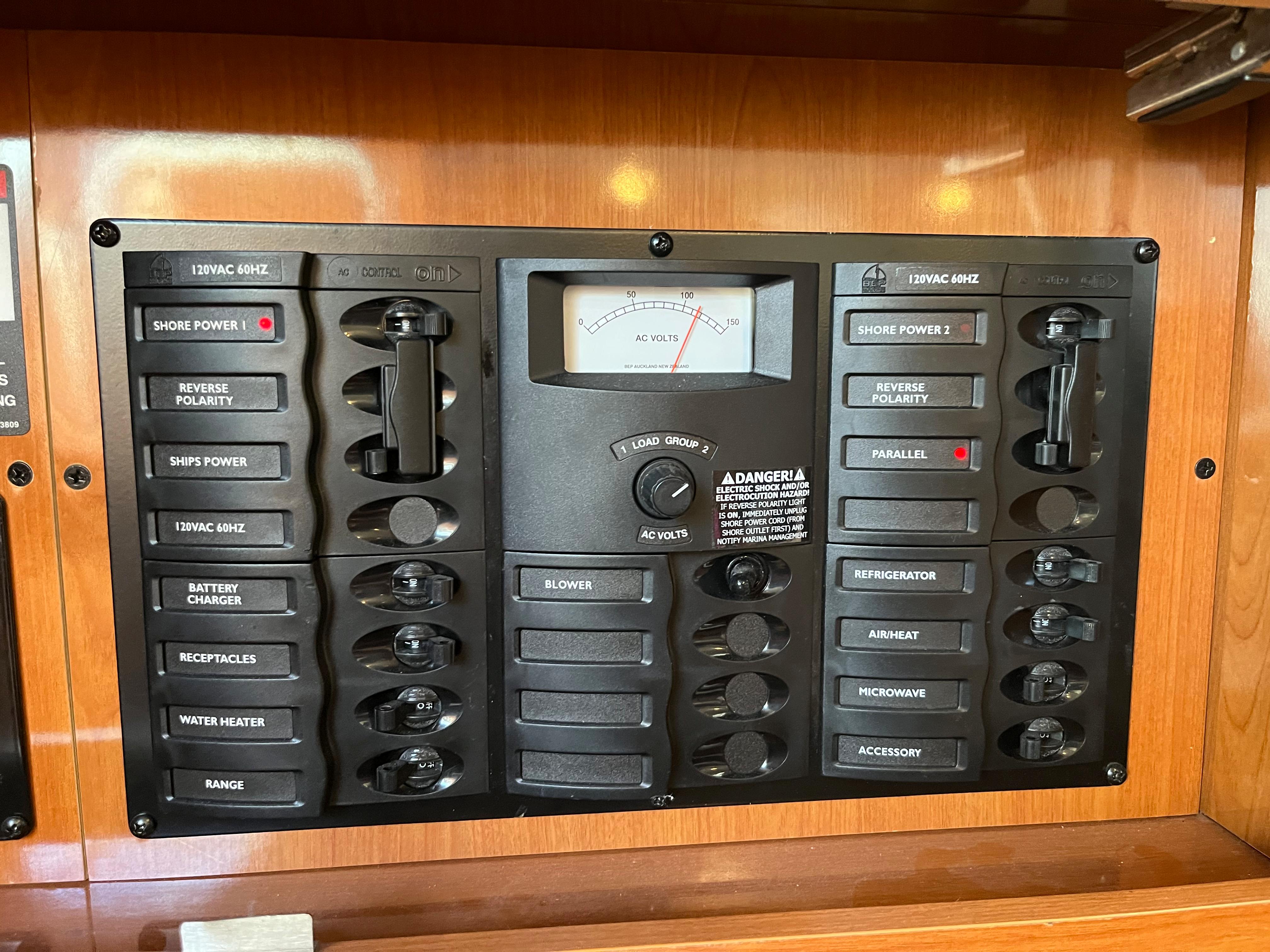 2009 Maxum 3100 SE electrical control panel with various switches and a voltage meter.