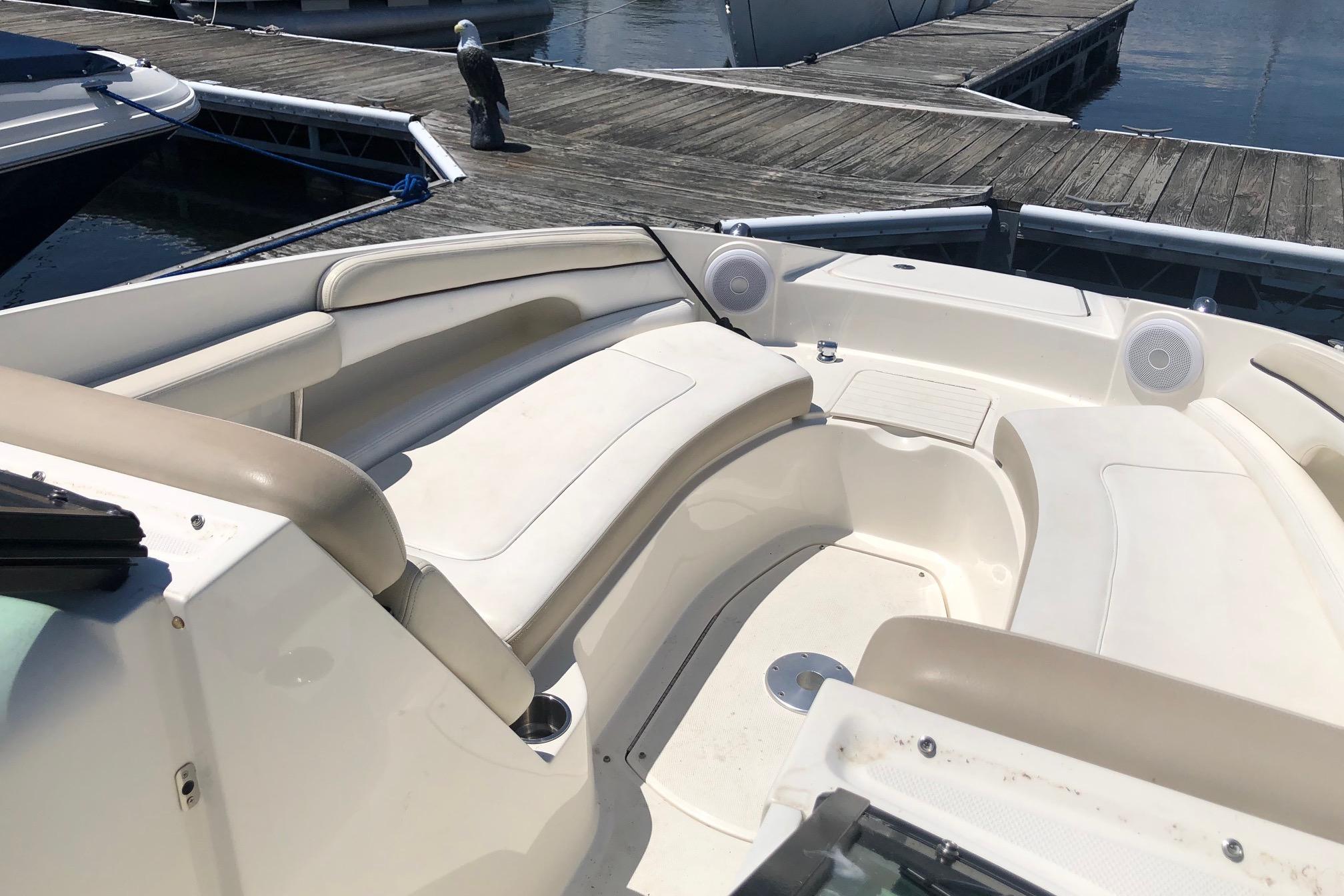 2013 Sea Ray 260 Sundeck boat interior with beige seating at a dock.
