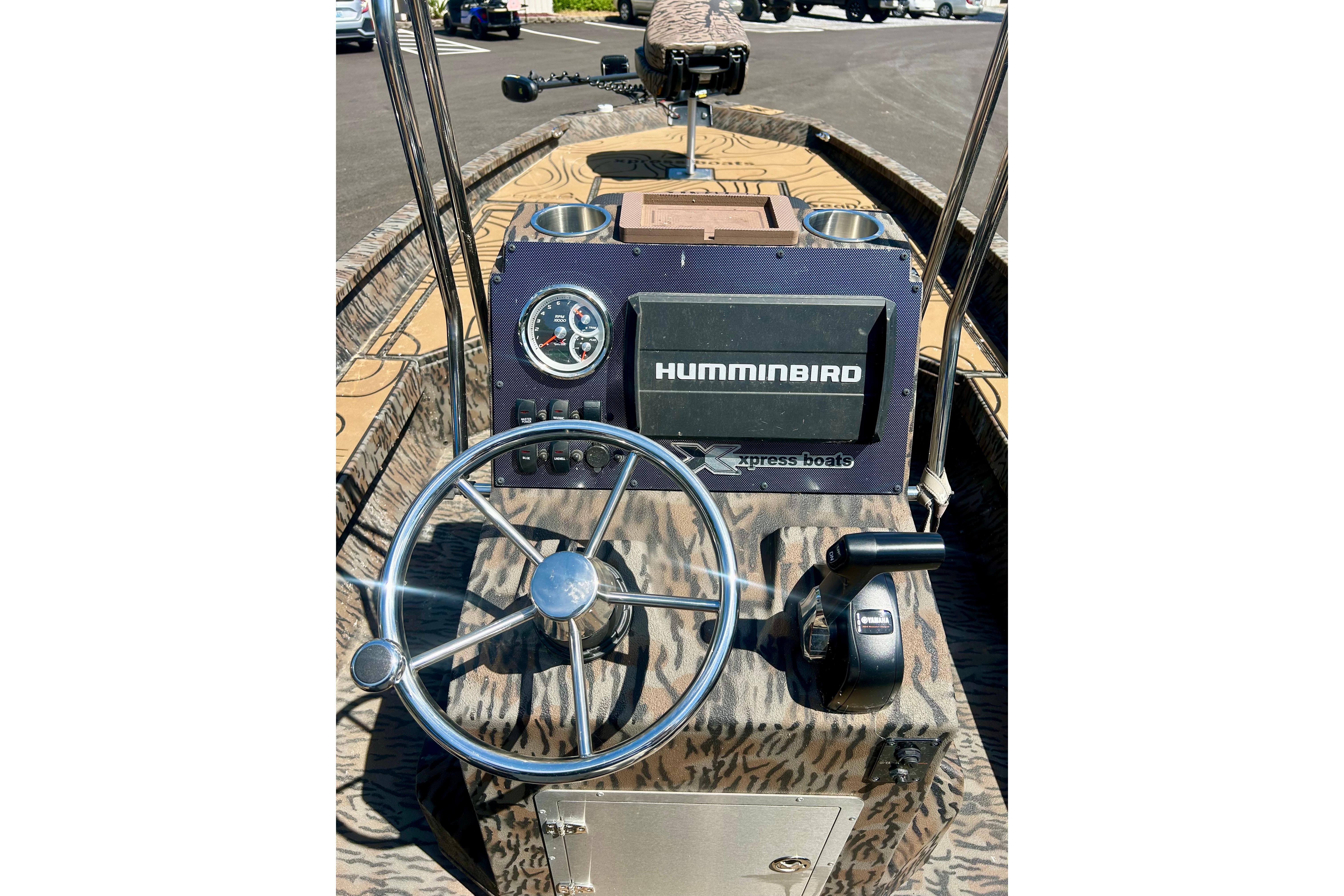 2025 Xpress H22B Bay boat dashboard with steering wheel and Humminbird electronics.