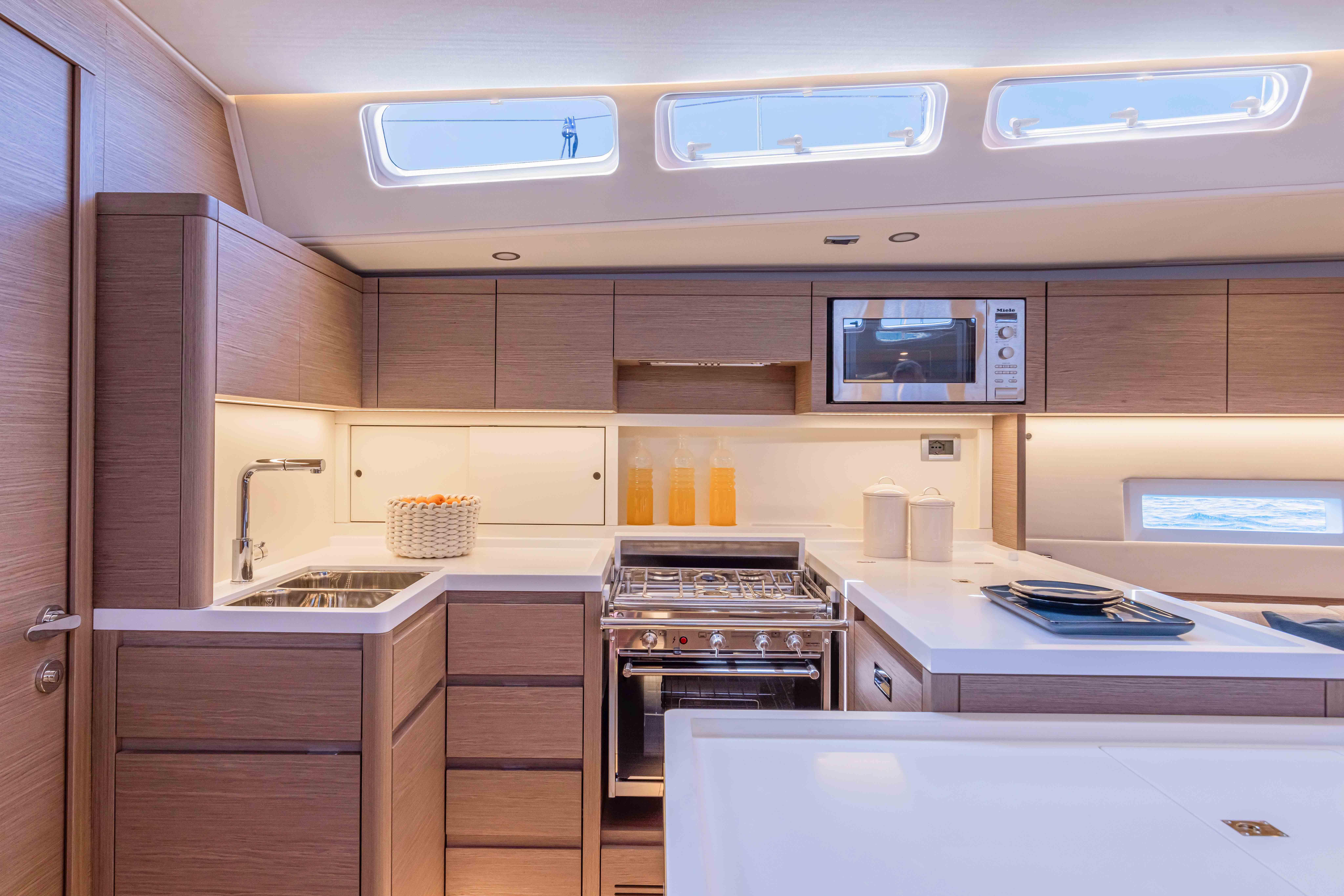 Modern kitchen interior of 2026 Grand Soleil 52 Performance yacht, featuring sleek cabinetry and appliances.