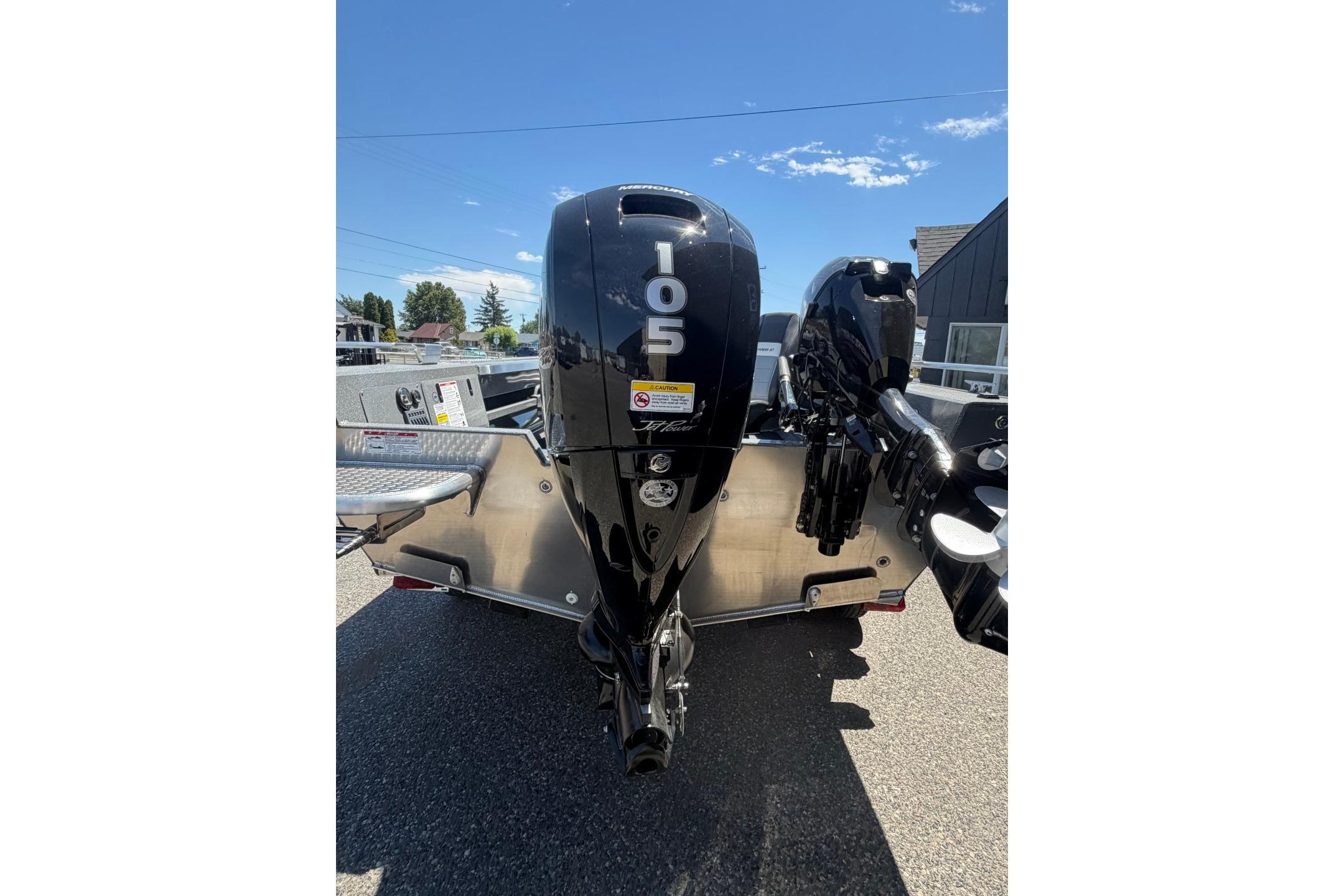 2026 Thunder Jet 209 Rush OT boat with powerful outboard motor, parked outdoors.