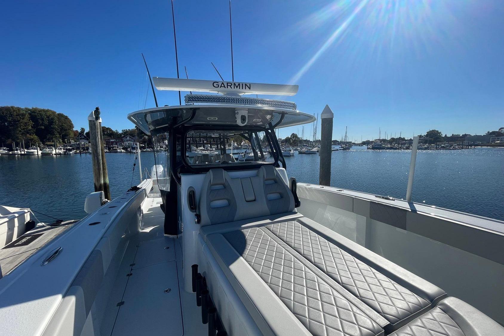 2024 Freeman 42LR boat docked, featuring sleek design and advanced Garmin navigation system.