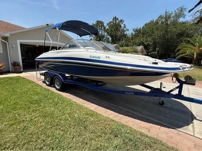 2011 Tahoe 216 WT boat on trailer in driveway.