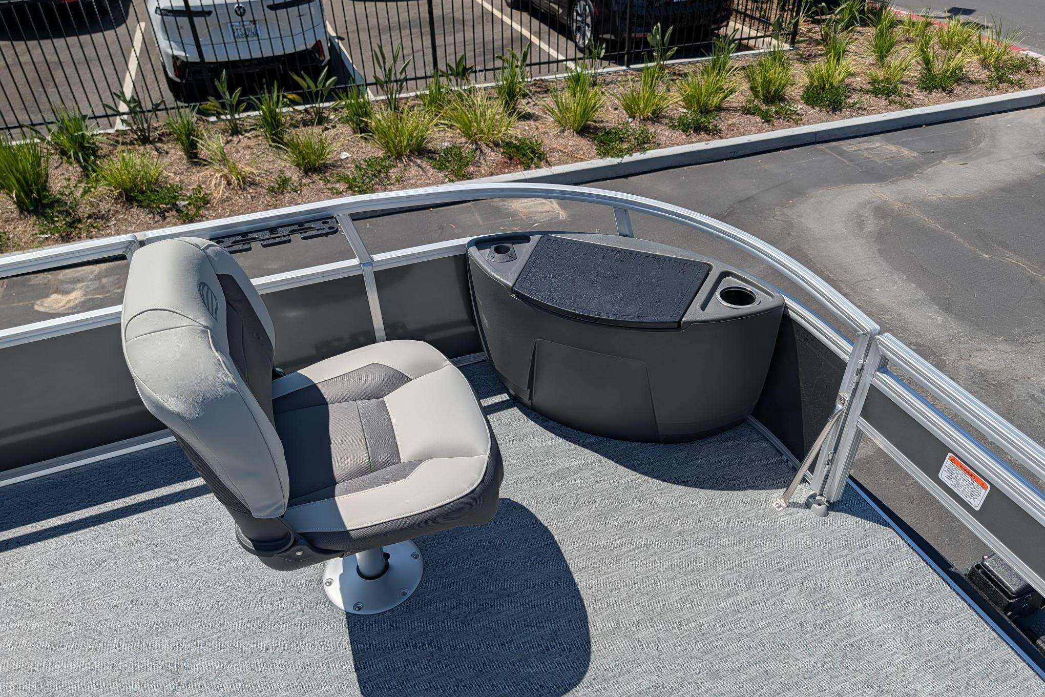 2026 Sun Tracker Bass Buggy 18 DLX pontoon boat with seating and storage area.