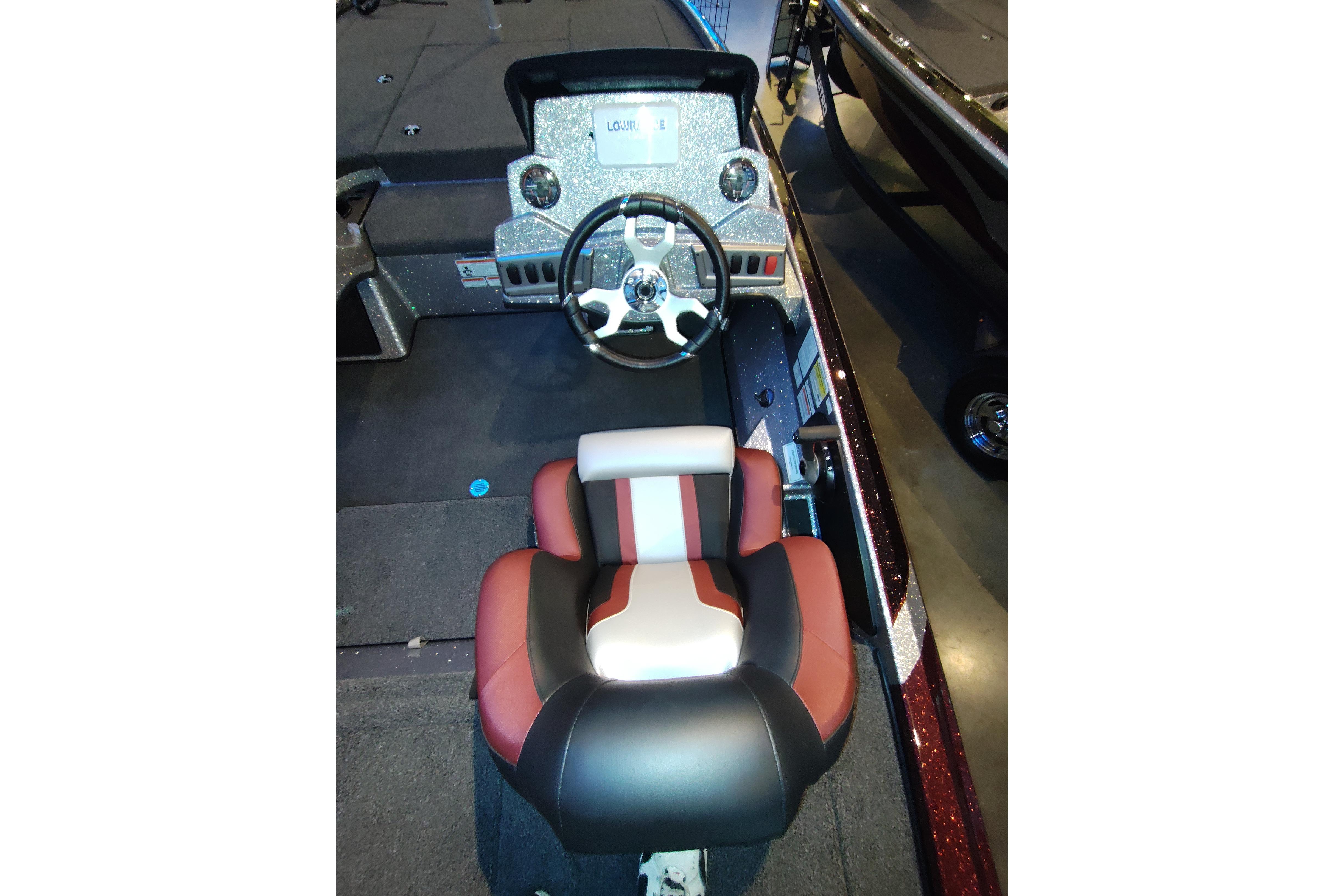 2026 Nitro Z18 boat interior with steering wheel and cushioned seat.