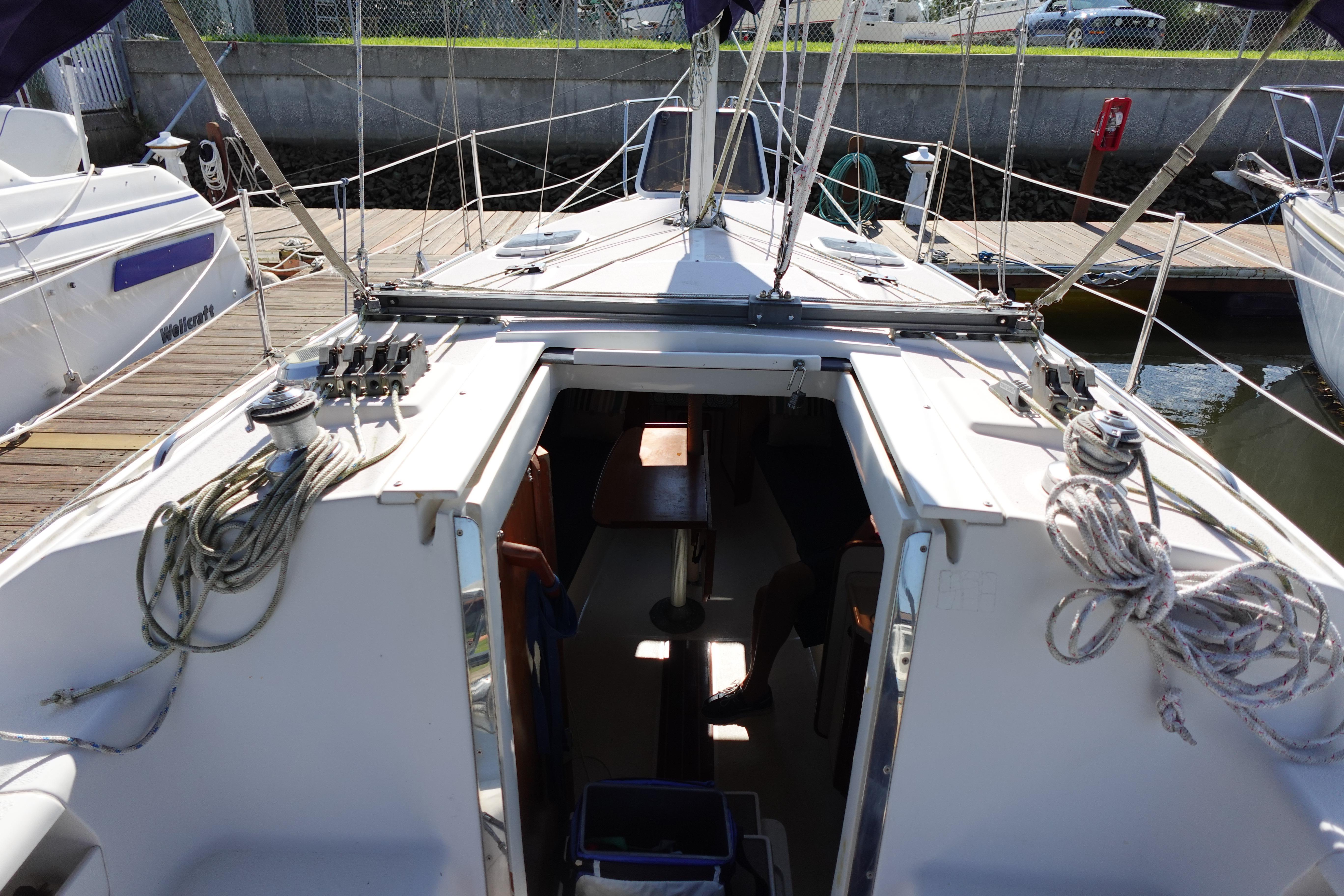 1997 Catalina 28 sailboat docked, showing cockpit and rigging details.