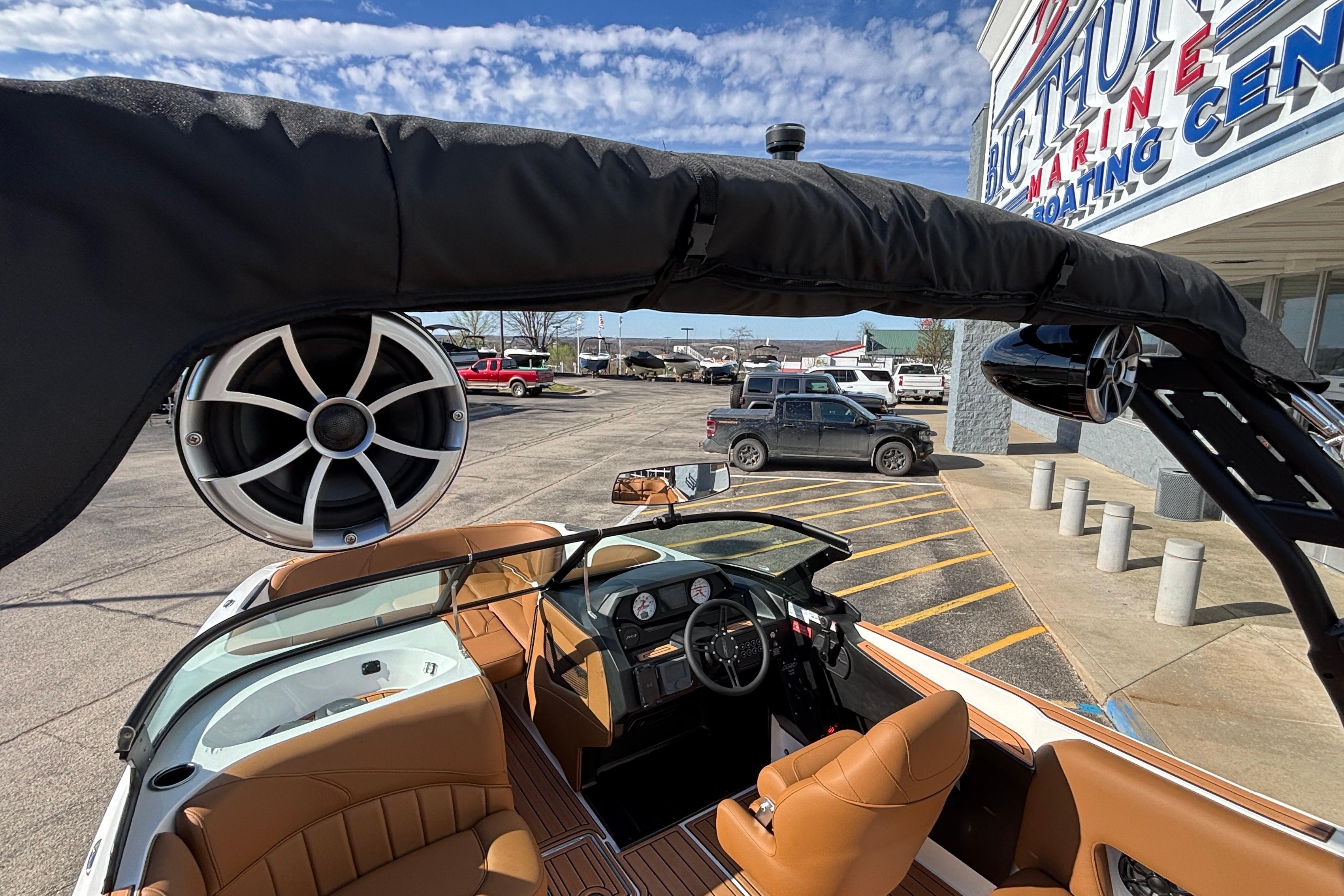 2026 MB SPORTS F21 Classic boat interior with speakers, parked at a marina.