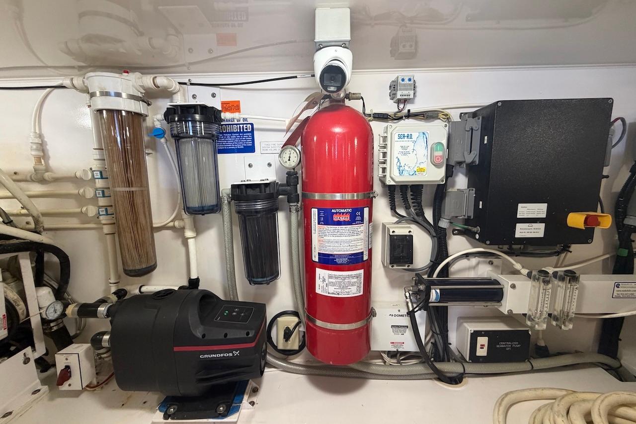 Engine room of a 2012 Viking 50 Convertible yacht with fire extinguisher and filtration system.