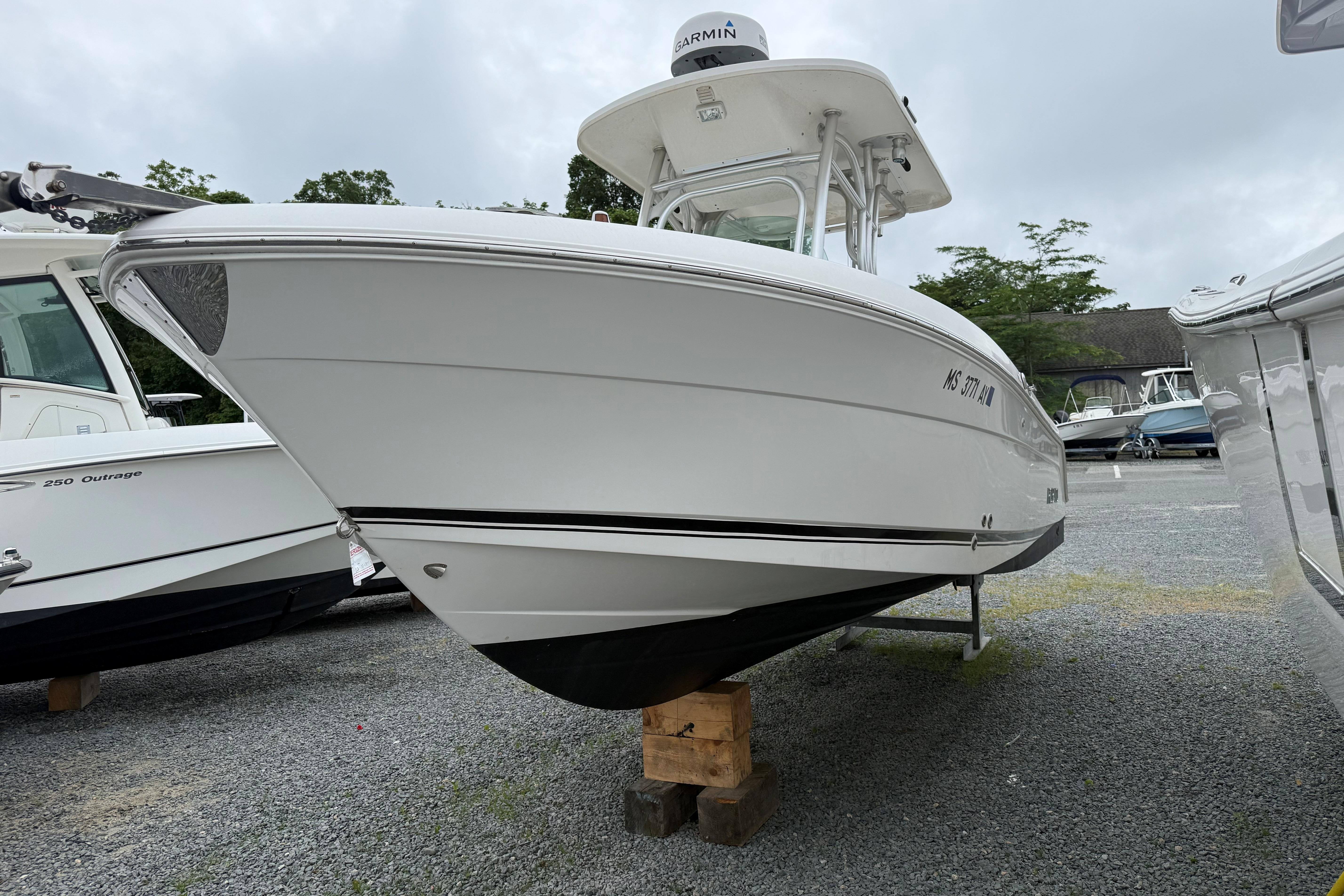2009 Robalo R240 Center Console boat on display in a gravel lot.