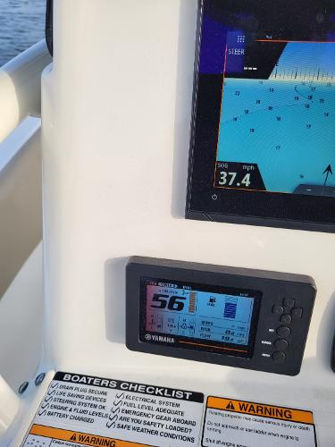 Control panel of a 2021 NauticStar 2302 Legacy boat with navigation and engine displays.