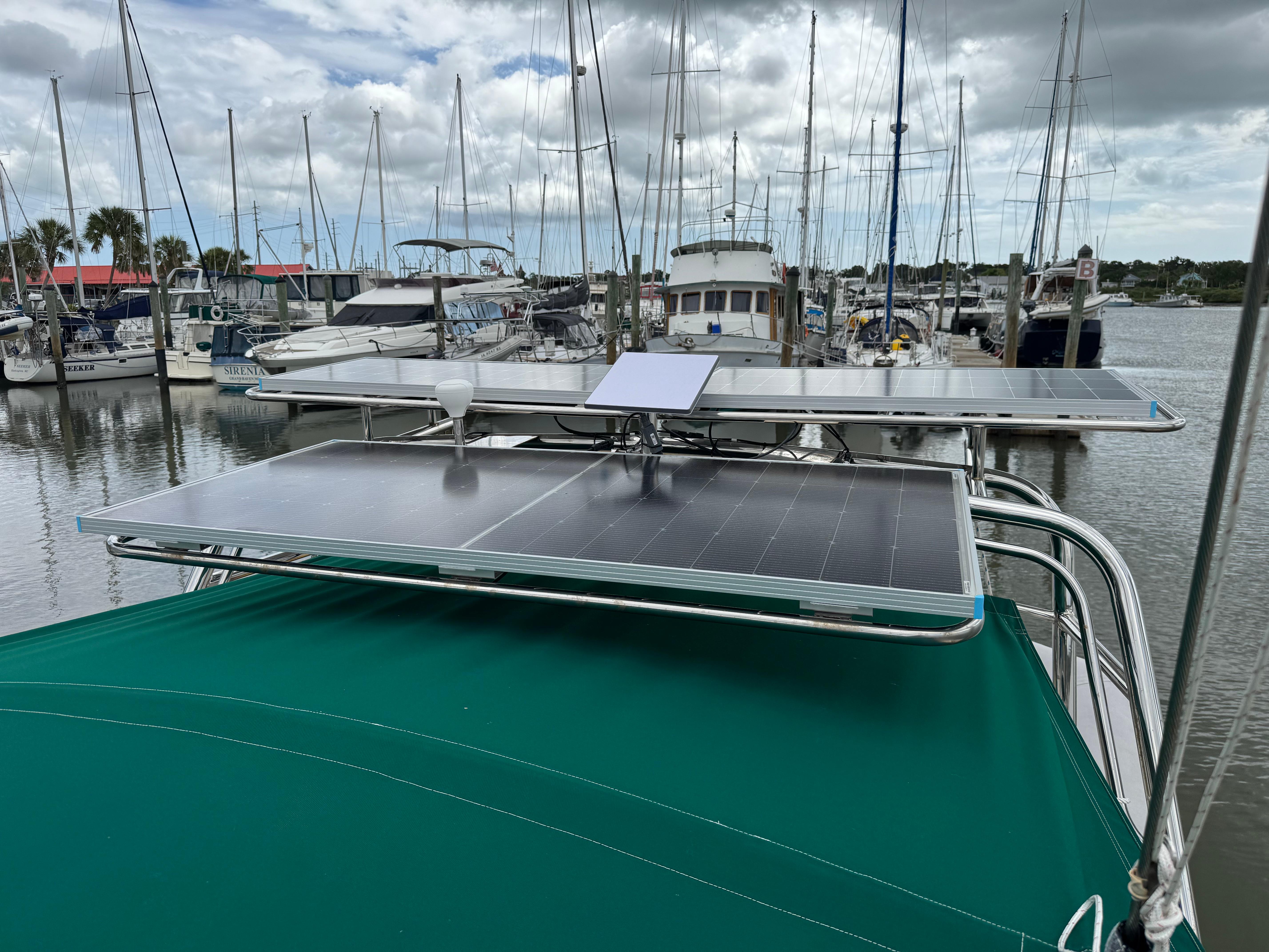 Beneteau Oceanis 461 sailboat with solar panels docked at a marina, 1997 model.