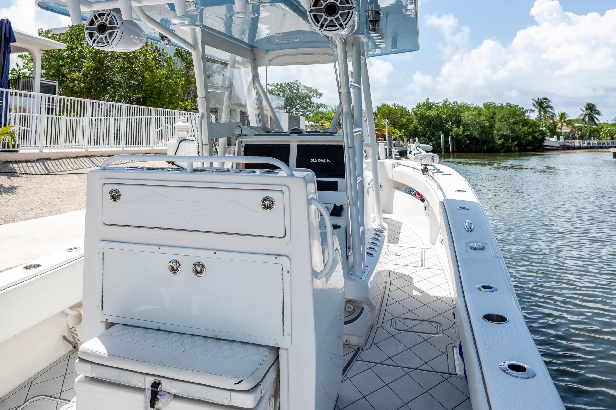 2021 Invincible 33 Open Fisherman boat with modern console and seating, docked by the water.