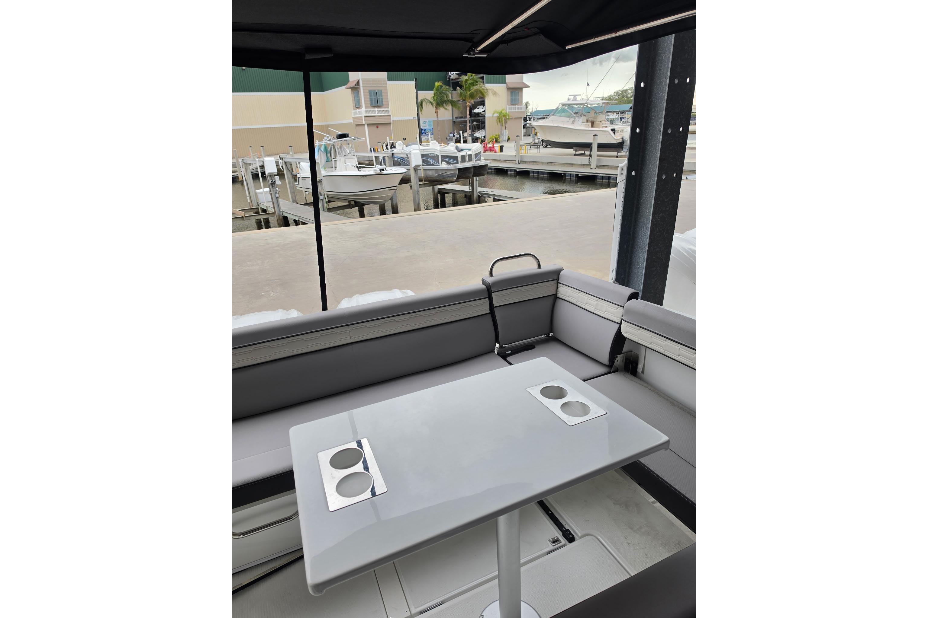 Interior of 2026 Jeanneau NC 895 Series 2 boat with sleek seating and table.