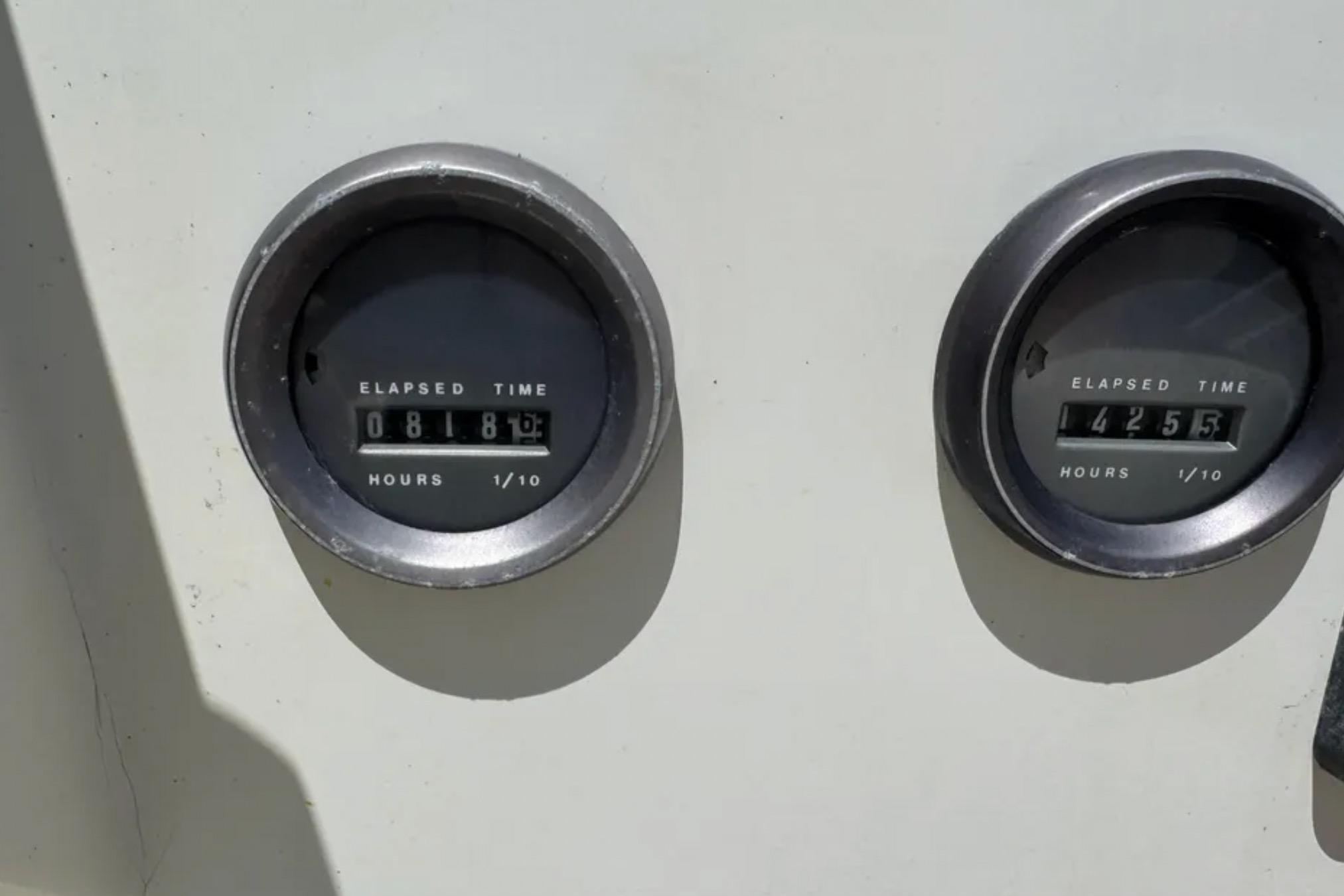 Elapsed time gauges on a 1988 Bertram 28 Sport Fisherman boat dashboard.