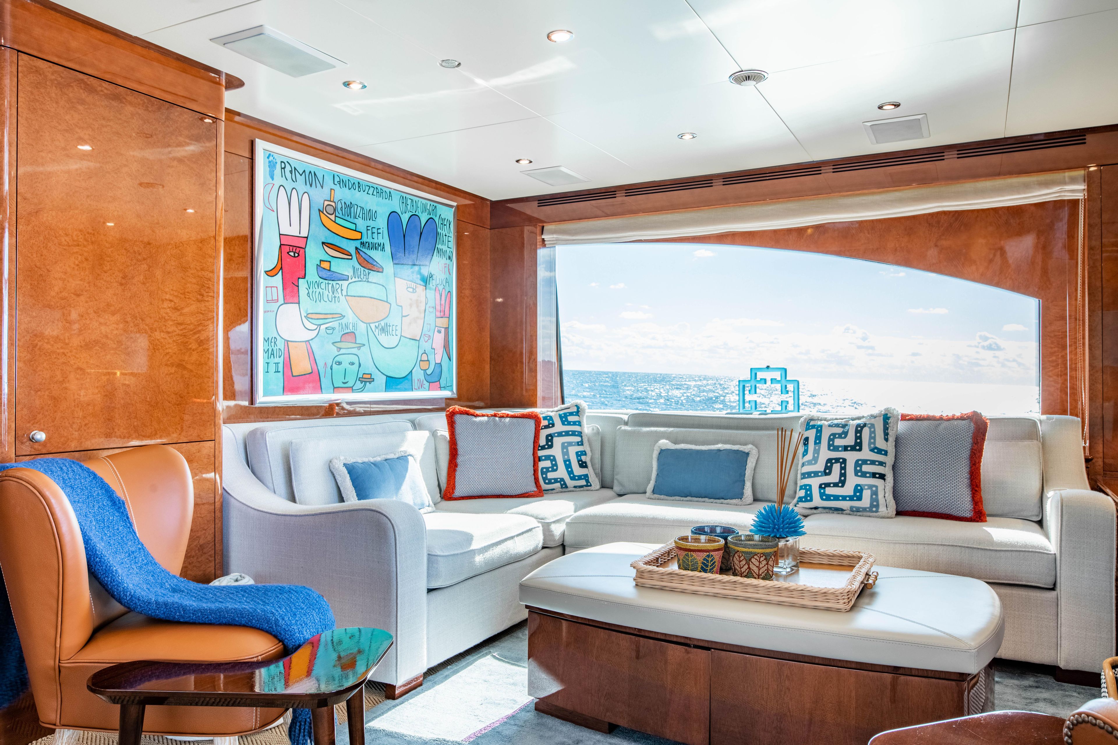 Luxurious Benetti 44 yacht interior, 2013 model, featuring elegant seating and vibrant artwork.