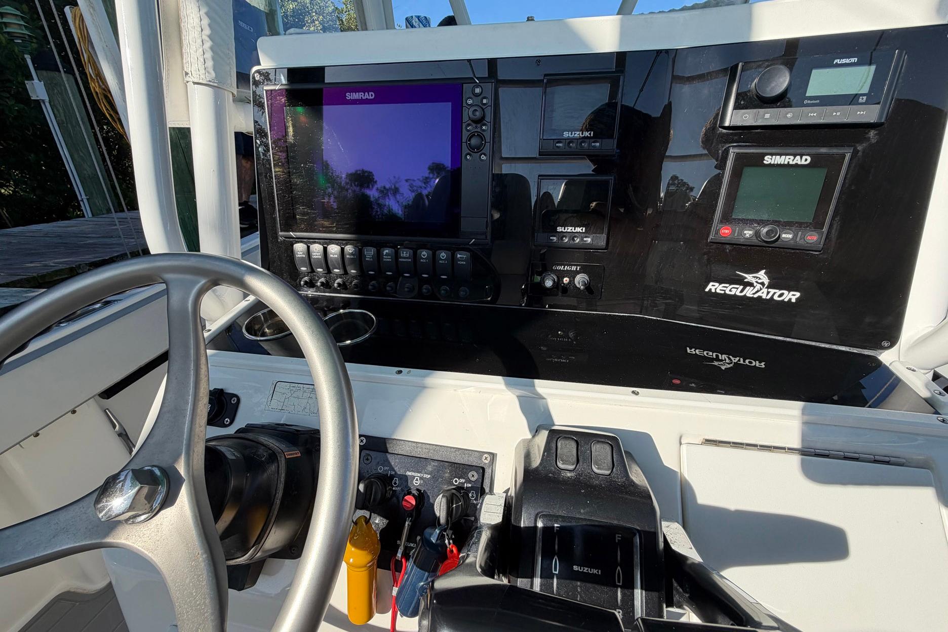 2002 Regulator 26 Center Console dashboard with Simrad electronics and steering wheel.