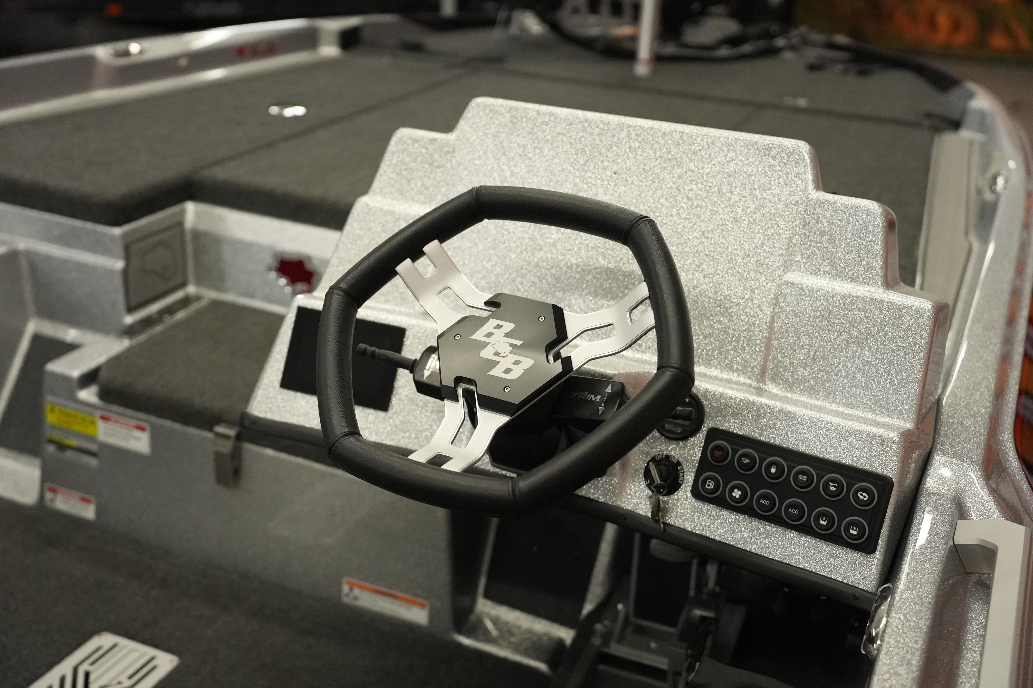 2026 Bass Cat Lynx STS boat steering wheel and control panel, featuring sleek design.