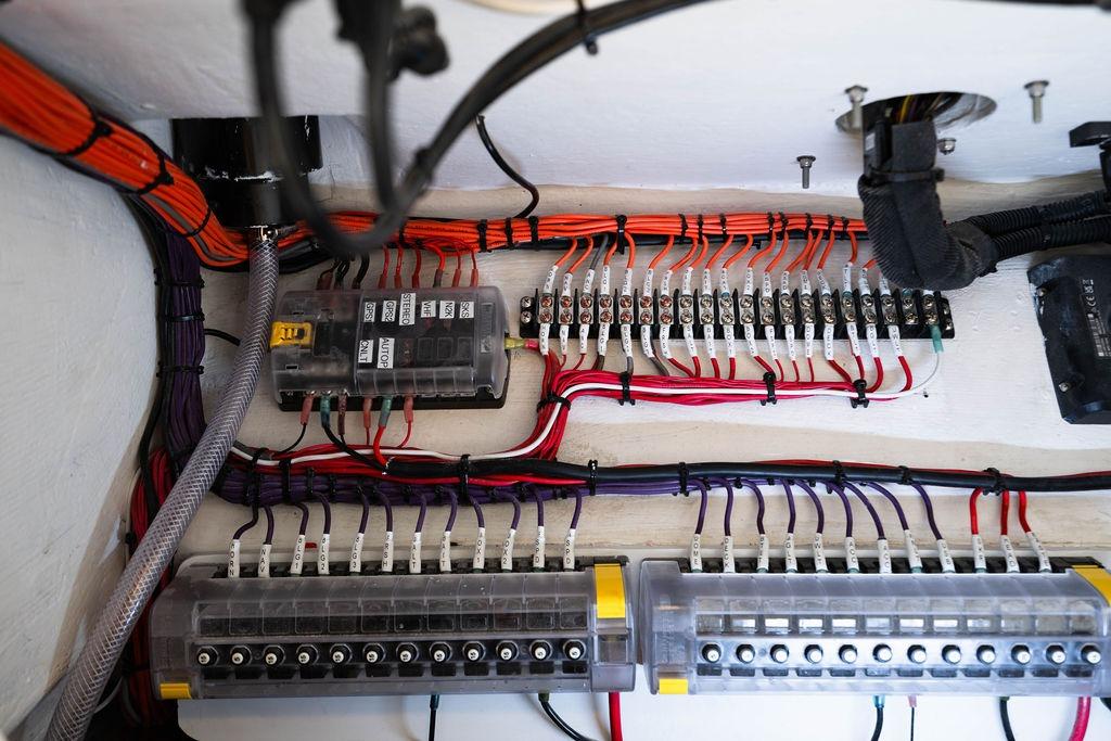 Electrical wiring and fuse panel inside a 2027 Reef Runner 340 boat.
