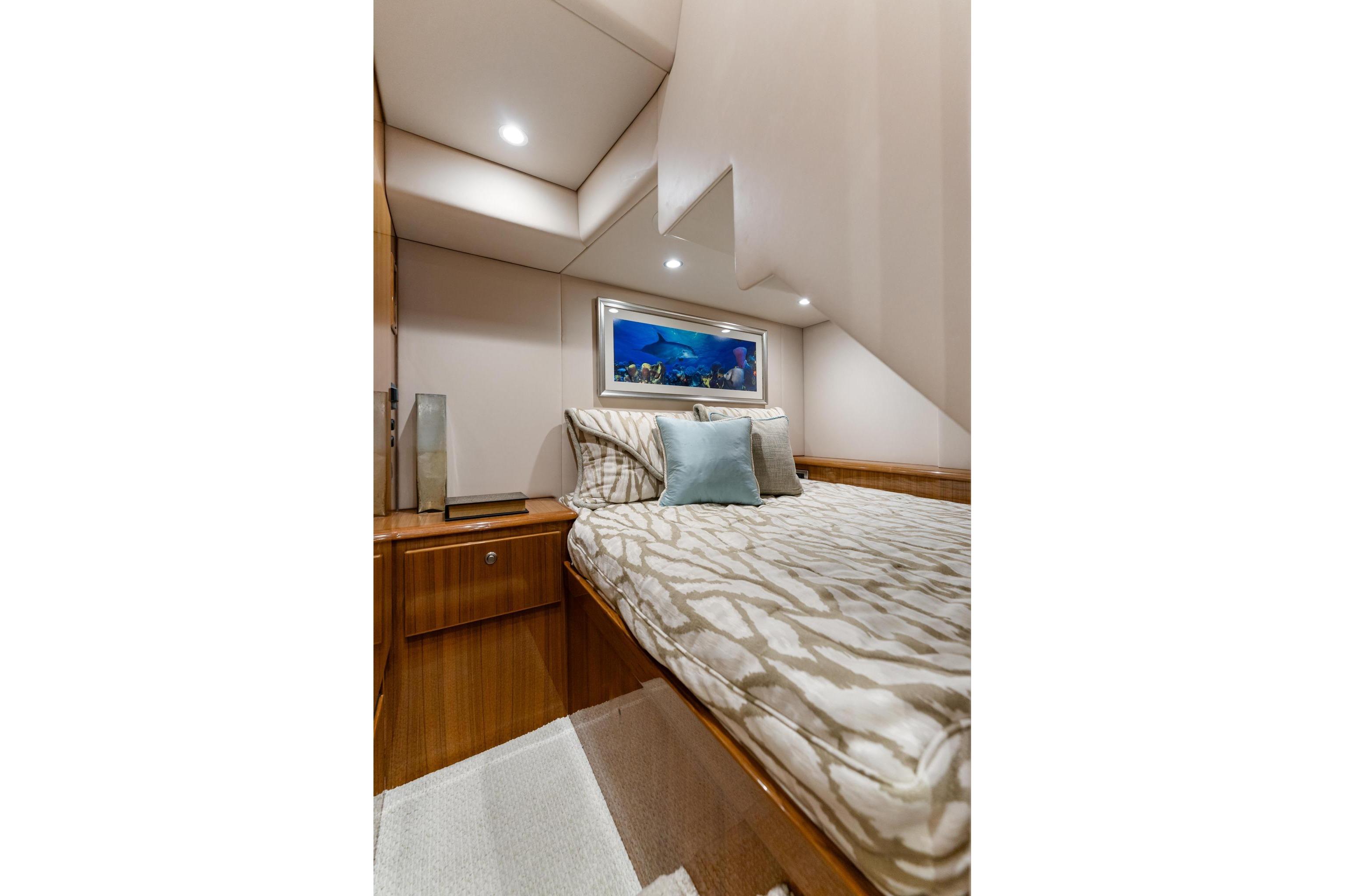 Luxurious cabin interior of 2018 Viking 44 Express yacht with elegant bedding and decor.
