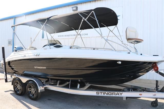 A black 2022 Stingray 212 SC boat on a trailer, featuring a sunshade.