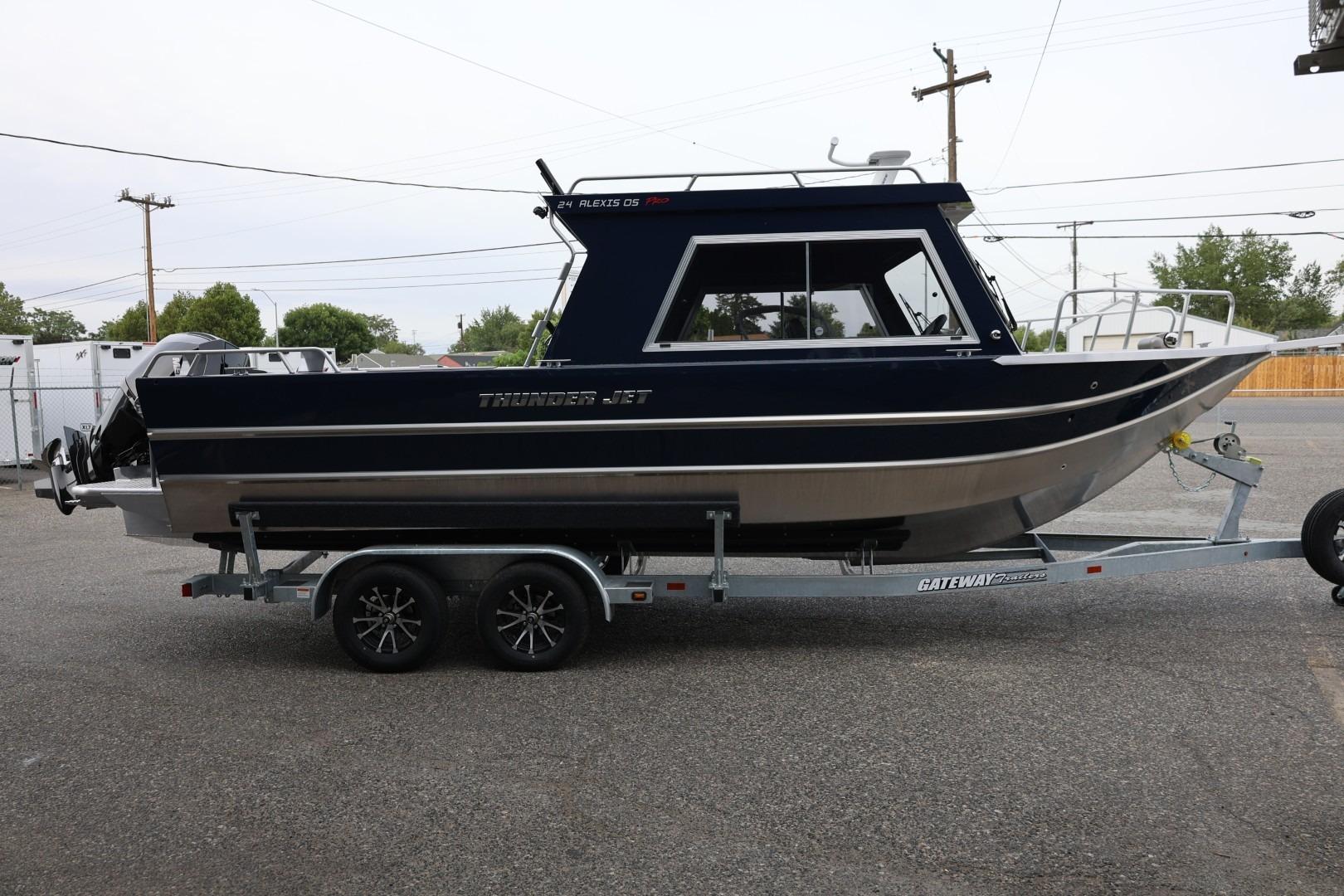 2026 Thunder Jet 24 Alexis Pro boat on trailer, side view in outdoor setting.