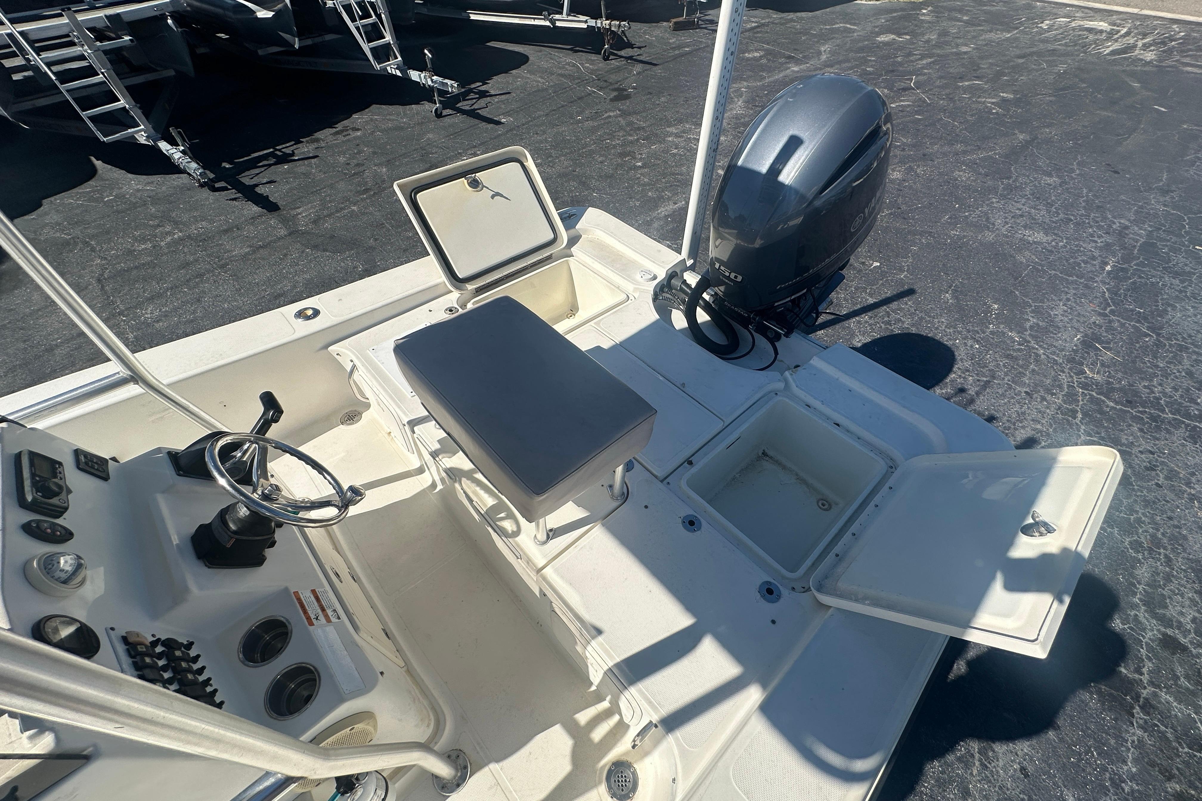 2003 Hydra-Sports 19 Bay Bolt boat interior with open storage compartments and outboard motor.