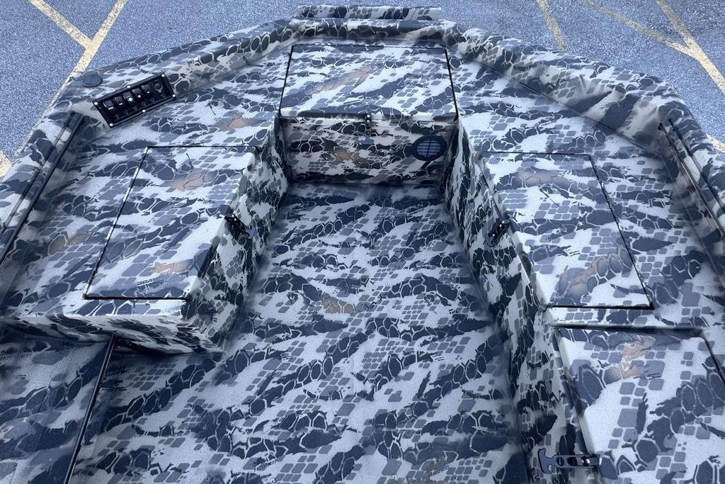 Camouflage interior of 2025 Havoc 1860 boat with storage compartments.