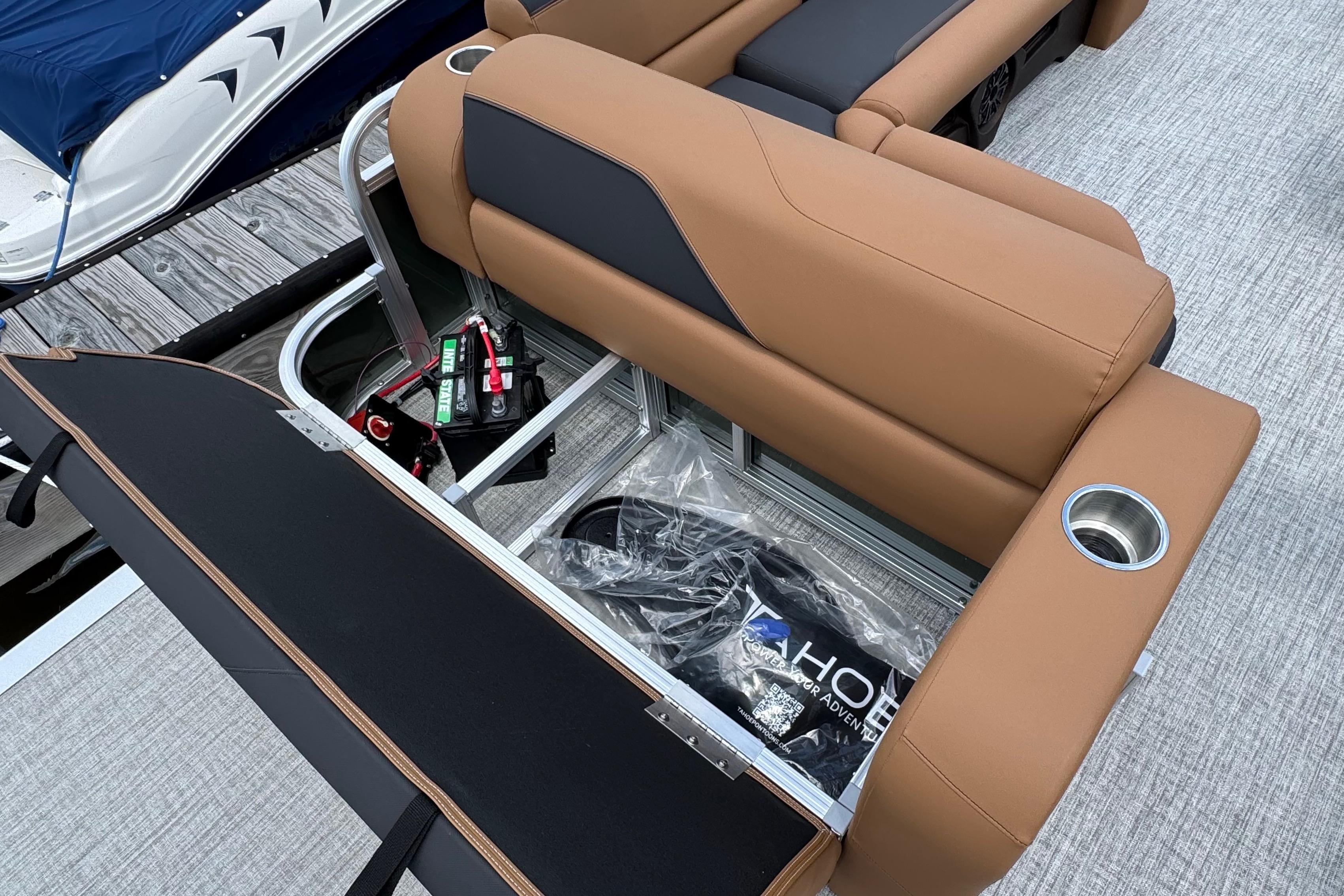 2026 Tahoe Pontoon Sport 85 Cruise Rear Bench 23 with storage compartment open on a dock.