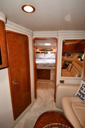 Interior of 2003 Sea Ray 460 Sundancer yacht, featuring cozy cabin and elegant wood finishes.